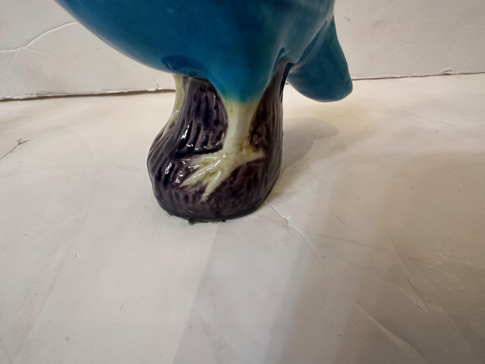 Pair of Chinese porcelain bluebirds having turquoise bodies and aubergine bases.
