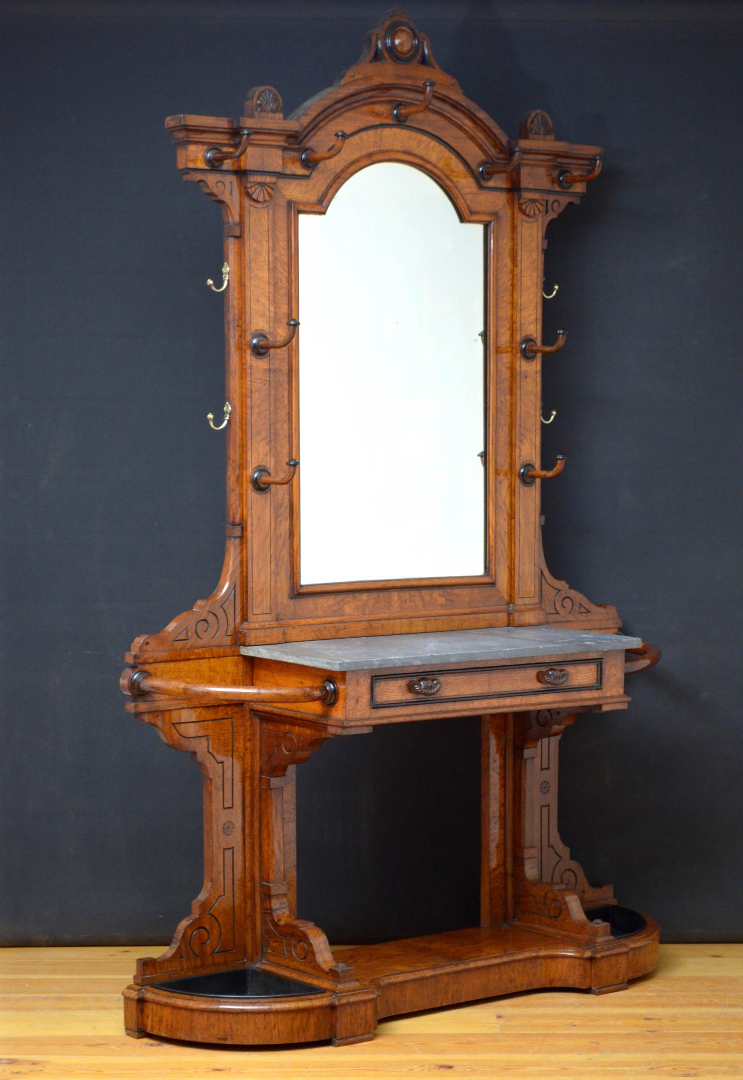 Sn4738 Grand Victorian oak and pollard oak hall stand possibly by Lamb of Manchester, having carved finial to arched top, original mirror with some foxing flanked by carved hooks and brass hooks to sides. The base having original marble top and a