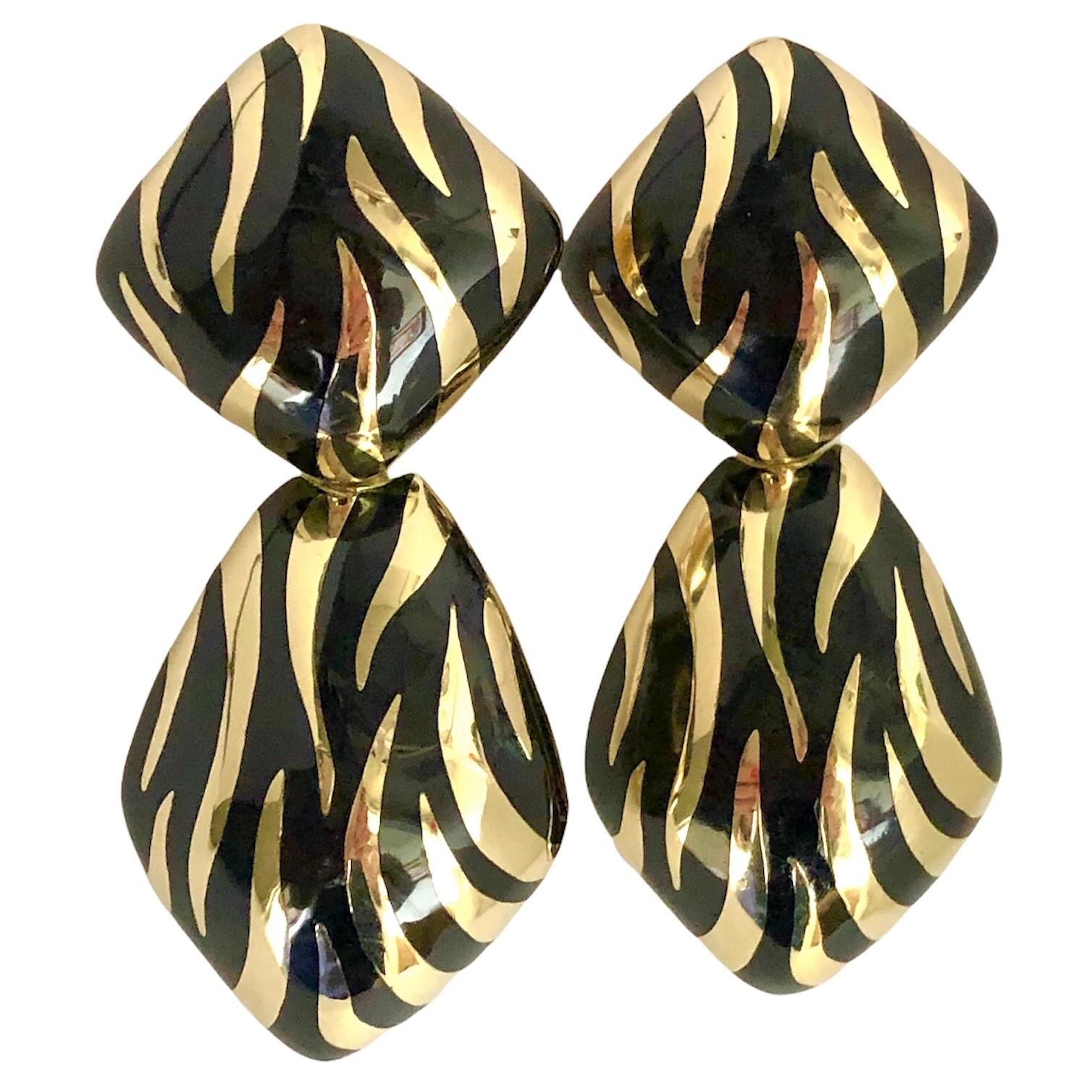 This bold pair of vintage hanging earrings are lavishly finished with black enamel tiger stripes over all of their surfaces. The effect is palpable and the artisan quality is very high. Stamped 14k gold. Measures  2 1/8 inches in length by and  7/8