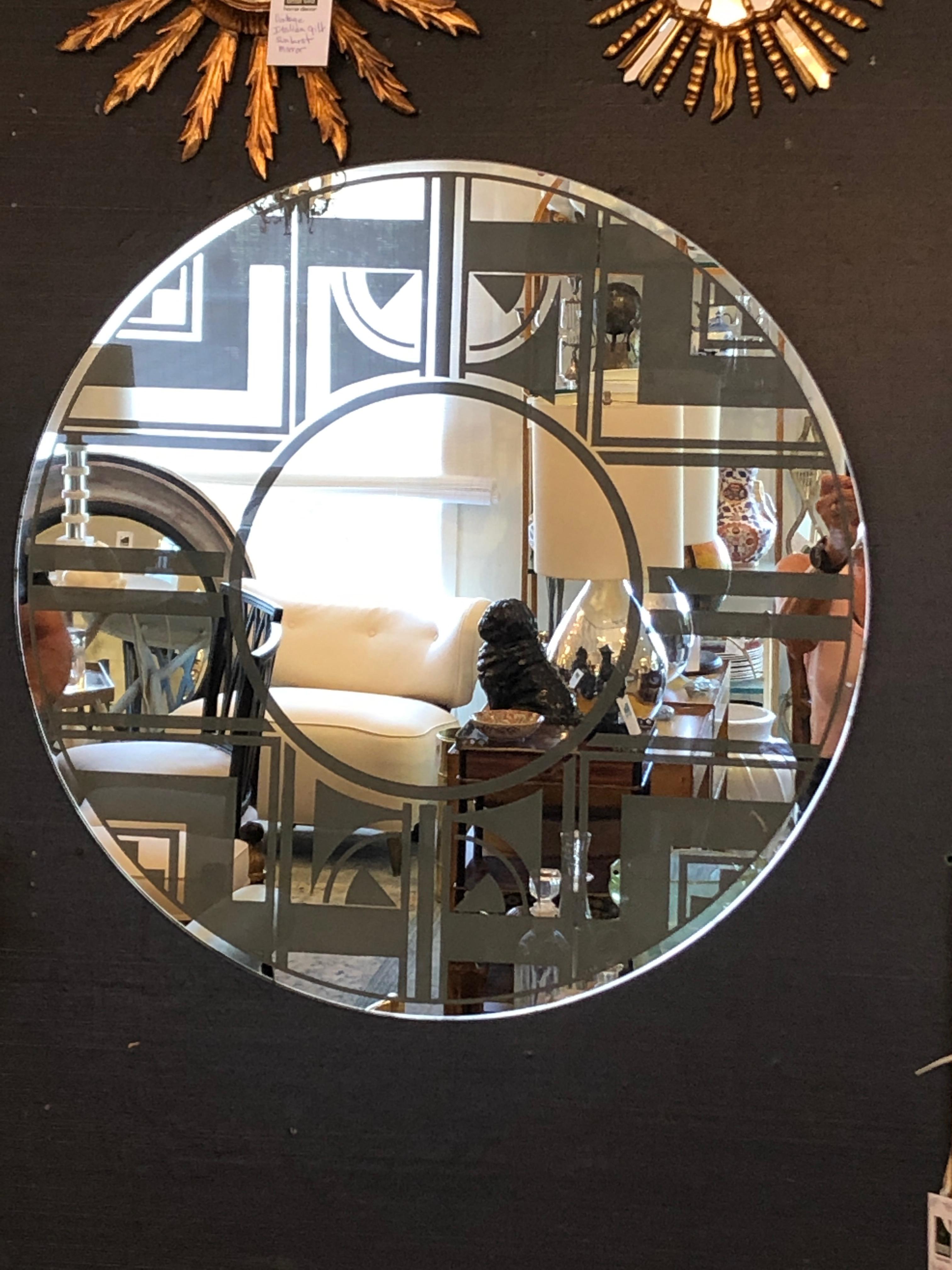 A sensational round etched mirror having Art Deco geometric design.