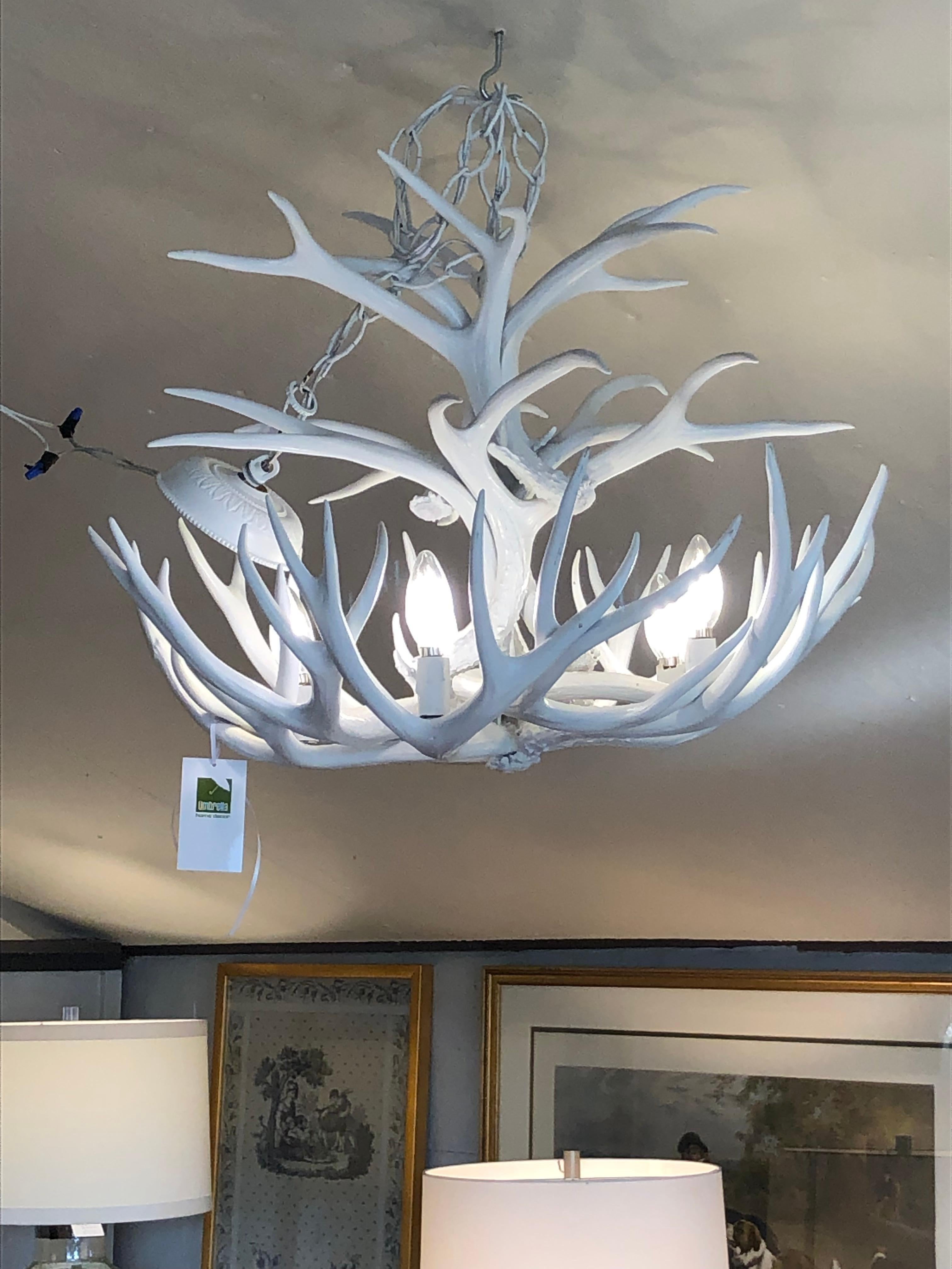 Striking nice sized antler chandelier painted white to give it a contemporary organic feel.  Brass canopy painted white is included.

Mara