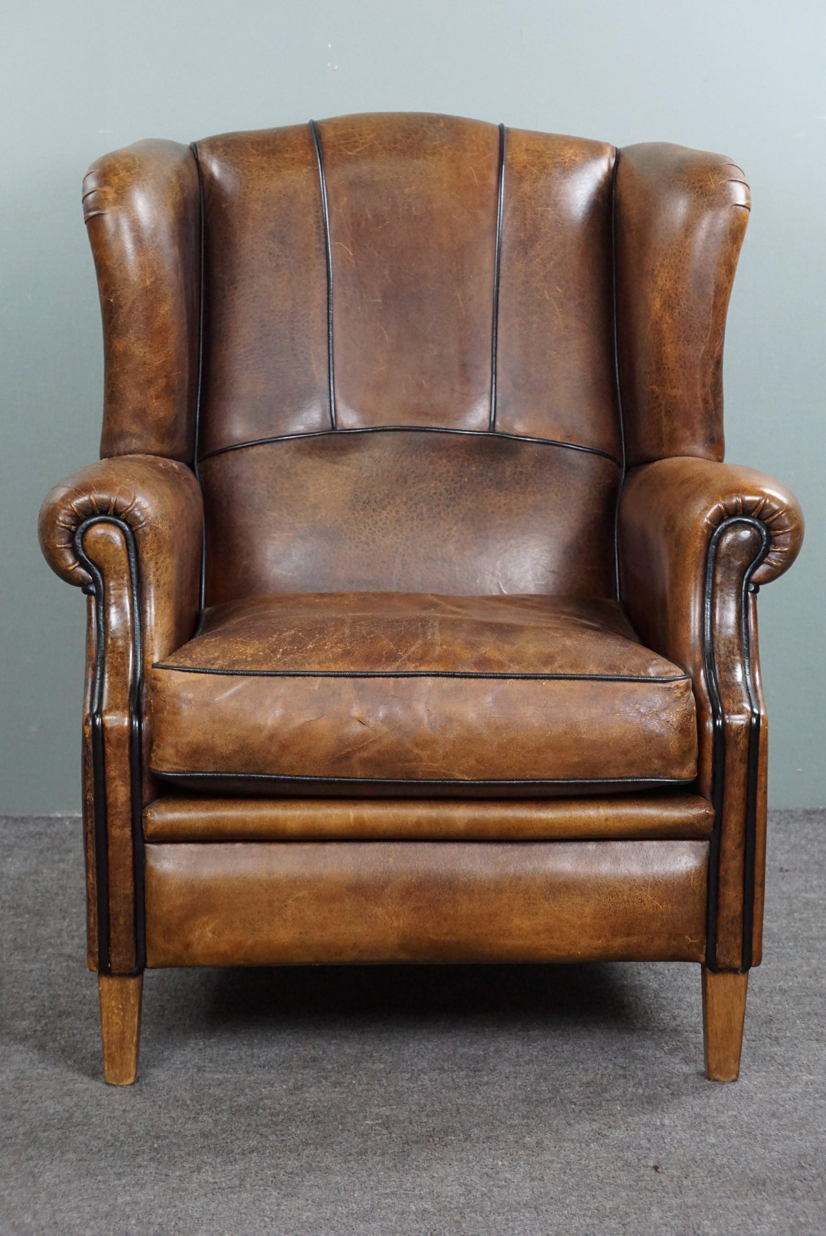 Offered byThijs is this well-fitting sheep leather wing chair with a very expressive division in the leather.

This sheepskin leather wing chair radiates character, with its sturdy appearance and cushion that testifies to years of comfortable