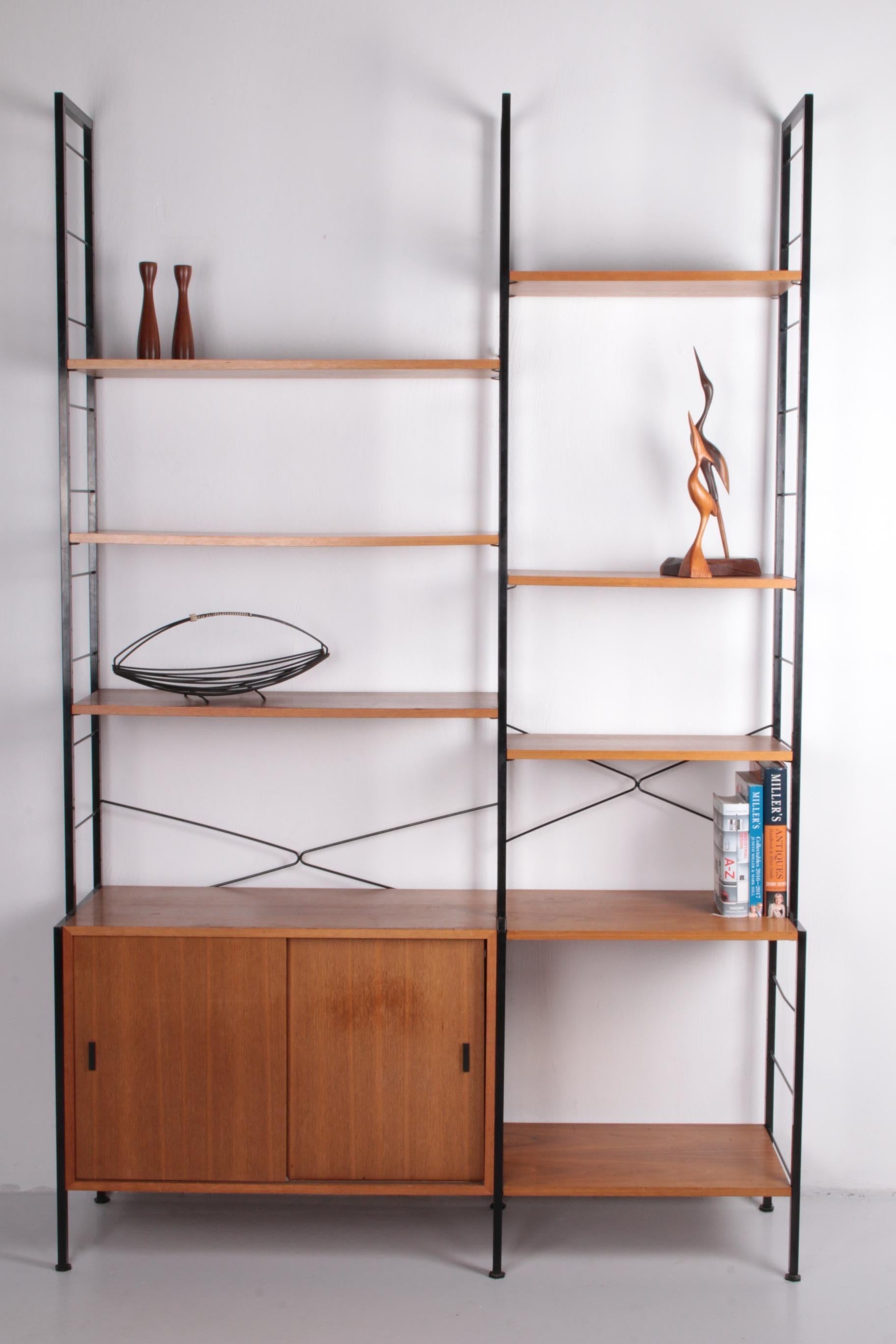 String Regal bookcase made in Germany, 1960s


Wall unit made in Germany in the 1970s.

Made of 1960s veneer wood.

It is still in a very nice vintage condition with normal signs of wear and patina. The bookshelf is characterized by its