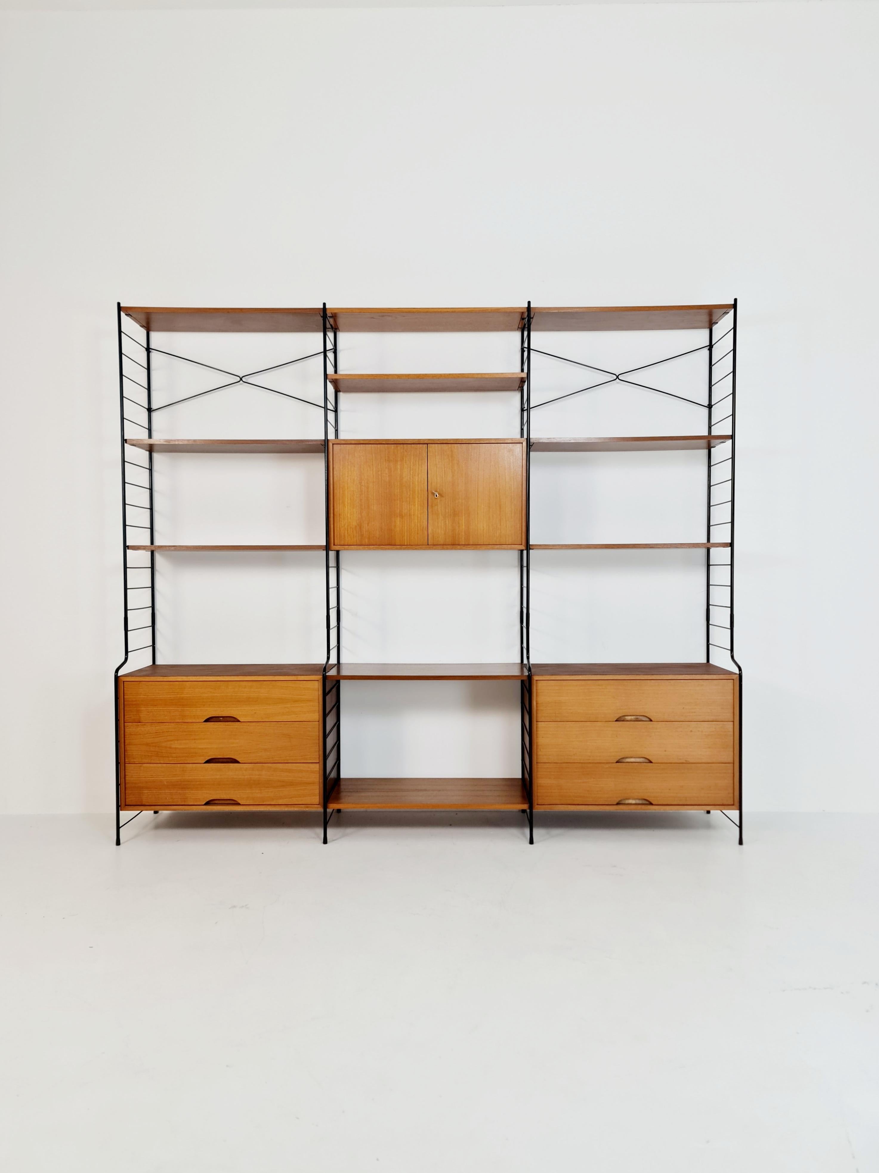 a very unique and wonderful String shelving system unite made of Teak wood by WHB Deutschland, 1960s

Dimentions:

H: 190 cm
W: 217 cm
D: 42 cm

The height of the base cabinets is 60 cm



worldwide shipping.