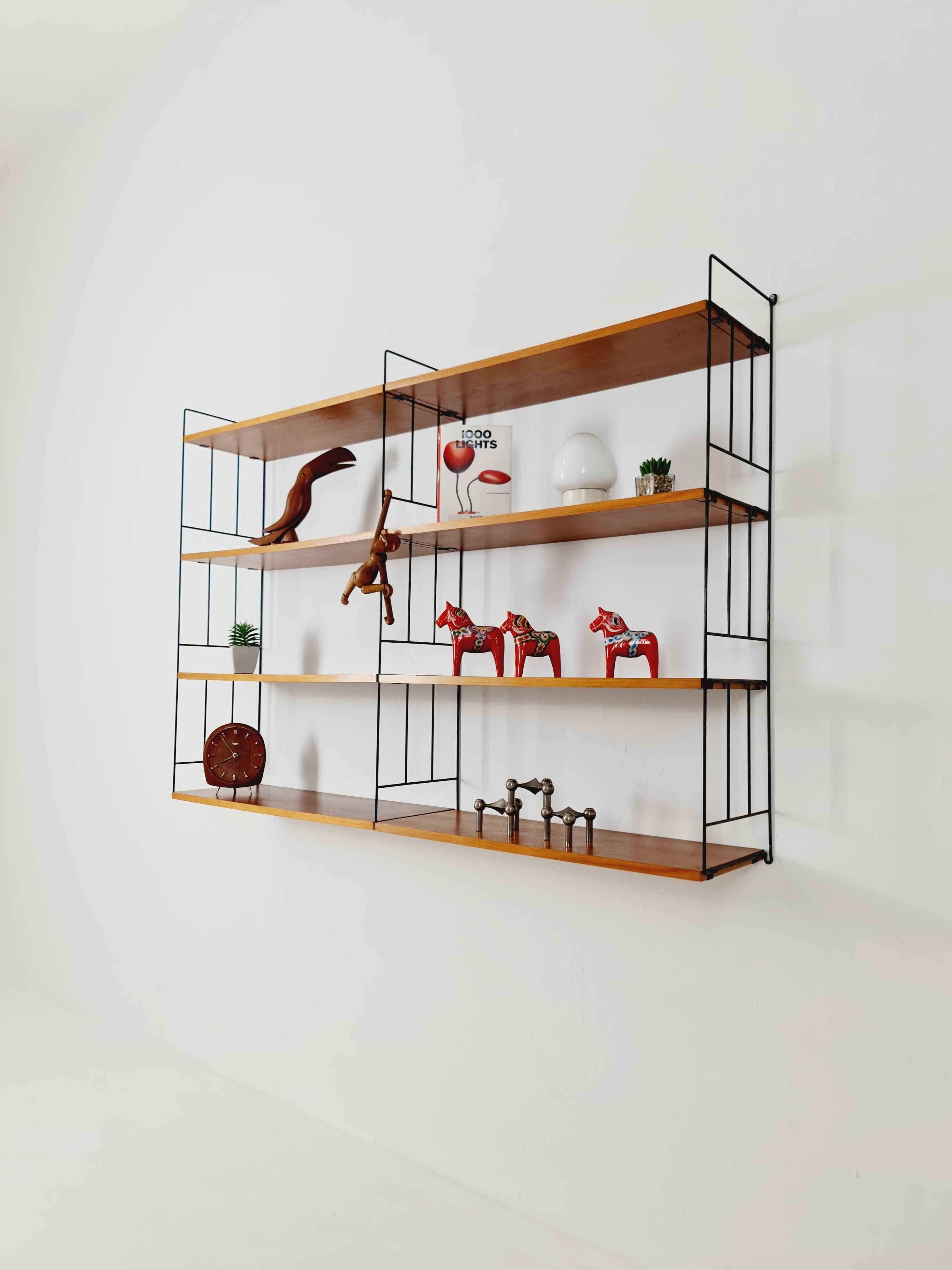 String shelf-system by WHB German, Teak 1950s

Measurements:
Height : 103   cm
Width : 144  cm 
Depth : 26cm 

Please inquiry for prices to your country before buying. 

A wooden crate may be used for intercontinental shipments for maximum