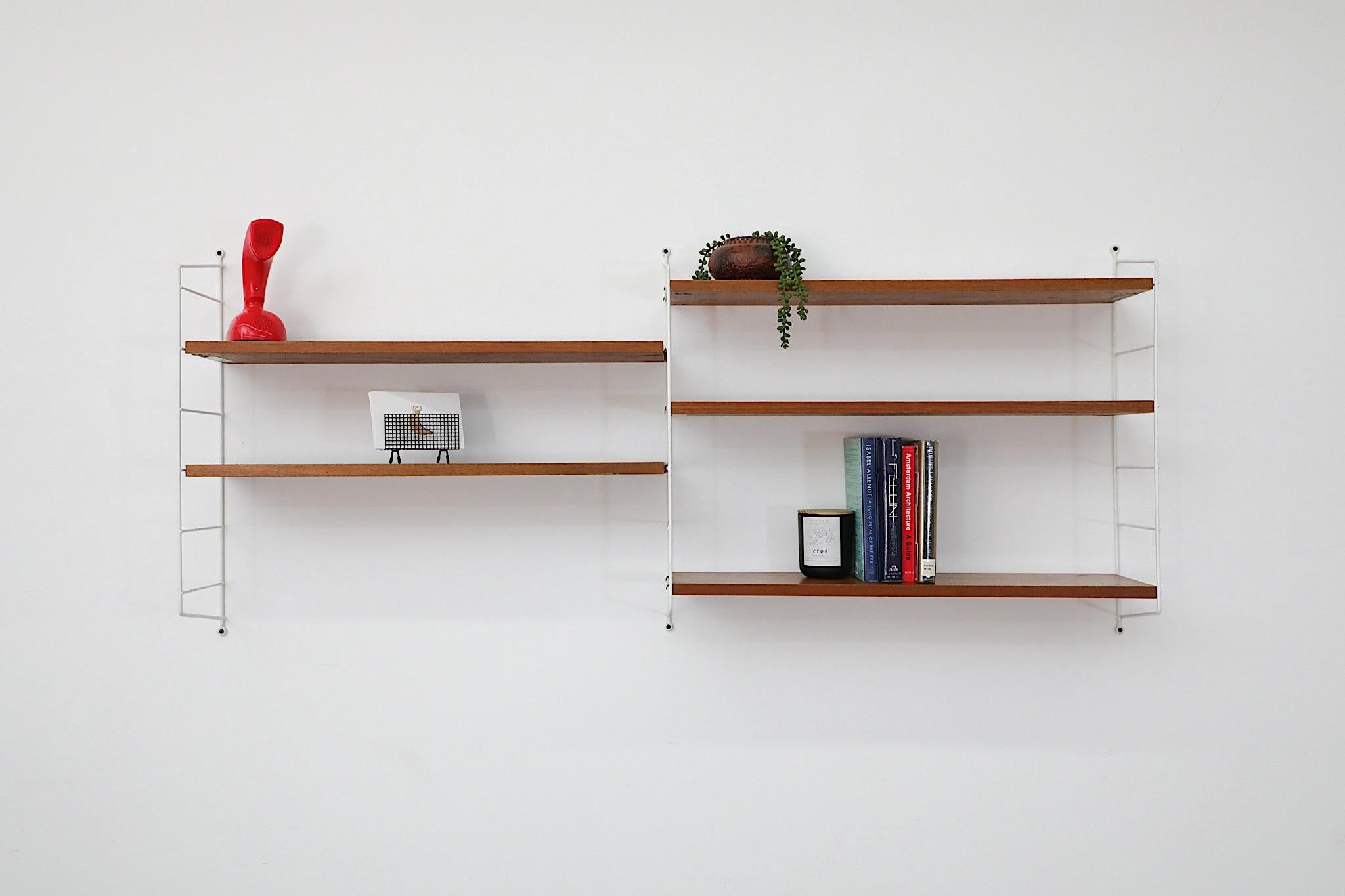 Classic Scandinavian Design String shelving system designed by Nisse Strinning for String, 1949. This two section shelving system has three white wire risers and five adjustable teak shelves. A functional and stylish shelving system with great style