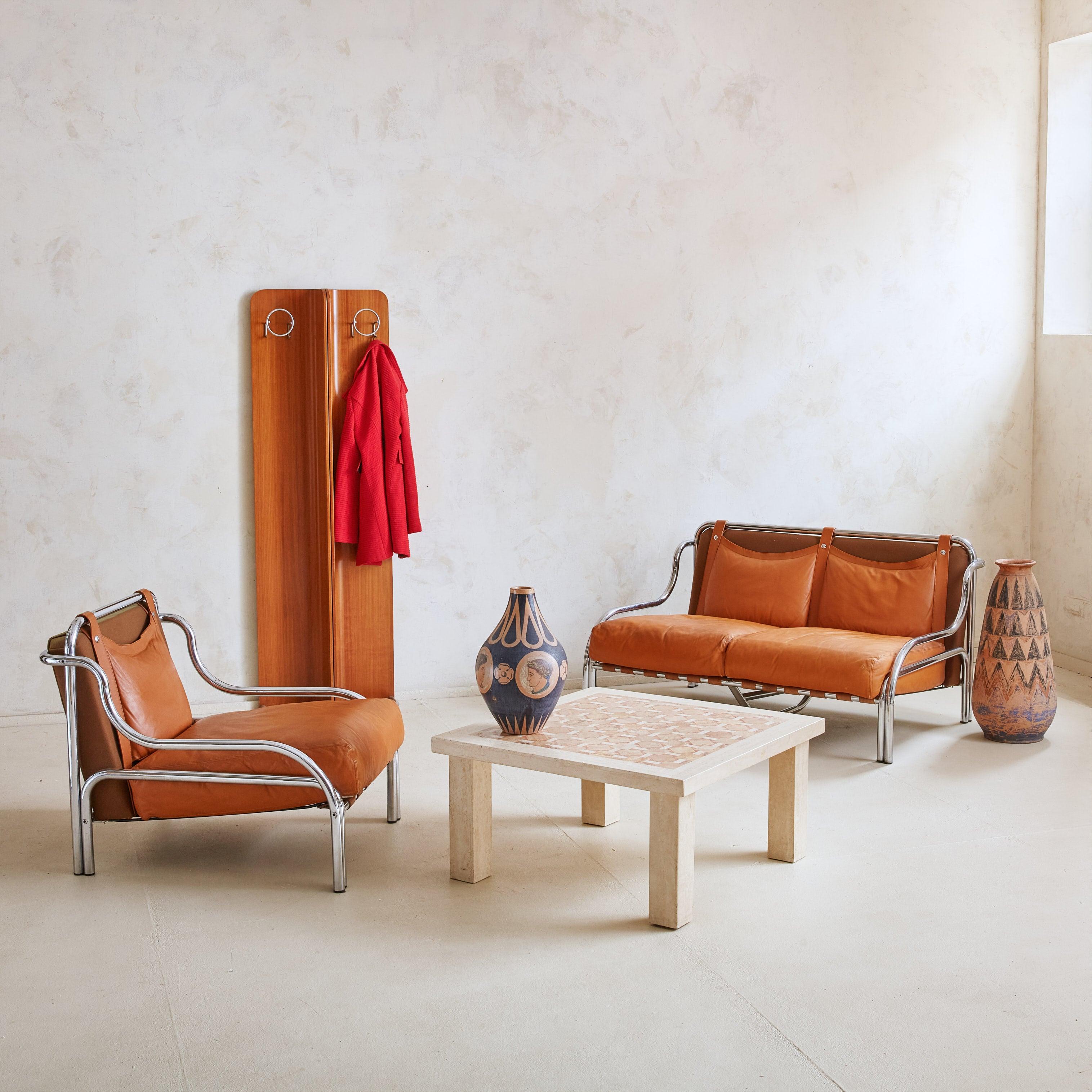 A rare ‘Stringa’ armchair designed by Gae Aulenti for Poltronova in the 1960s. This beautifully proportioned, sculptural armchair is constructed of tubular chromed metal and features a patinated cognac leather seat cushion. The padded back cushion