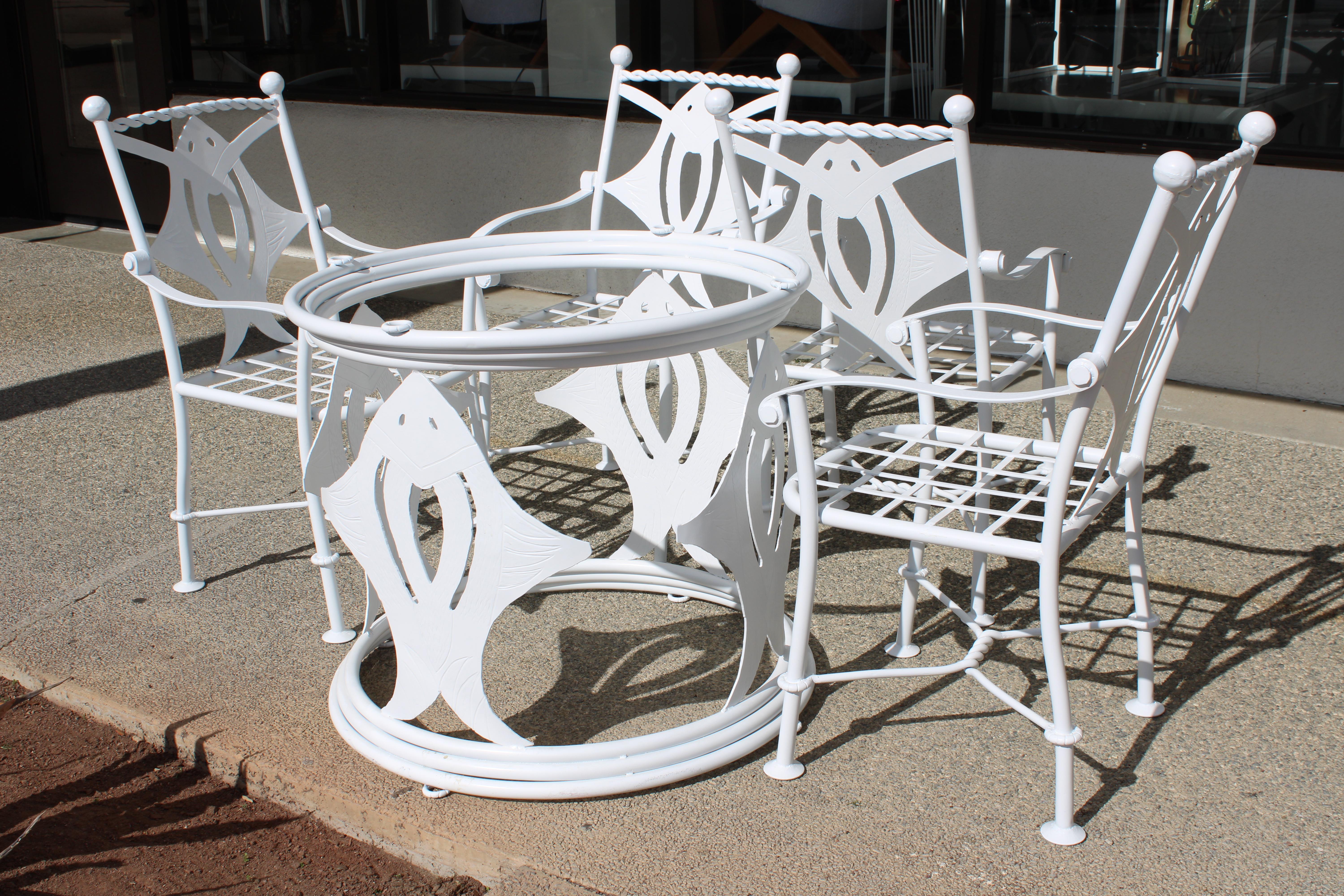 Patio set consisting of 4 chairs and table.   Beautiful stingray motif.  Table measures 28.5