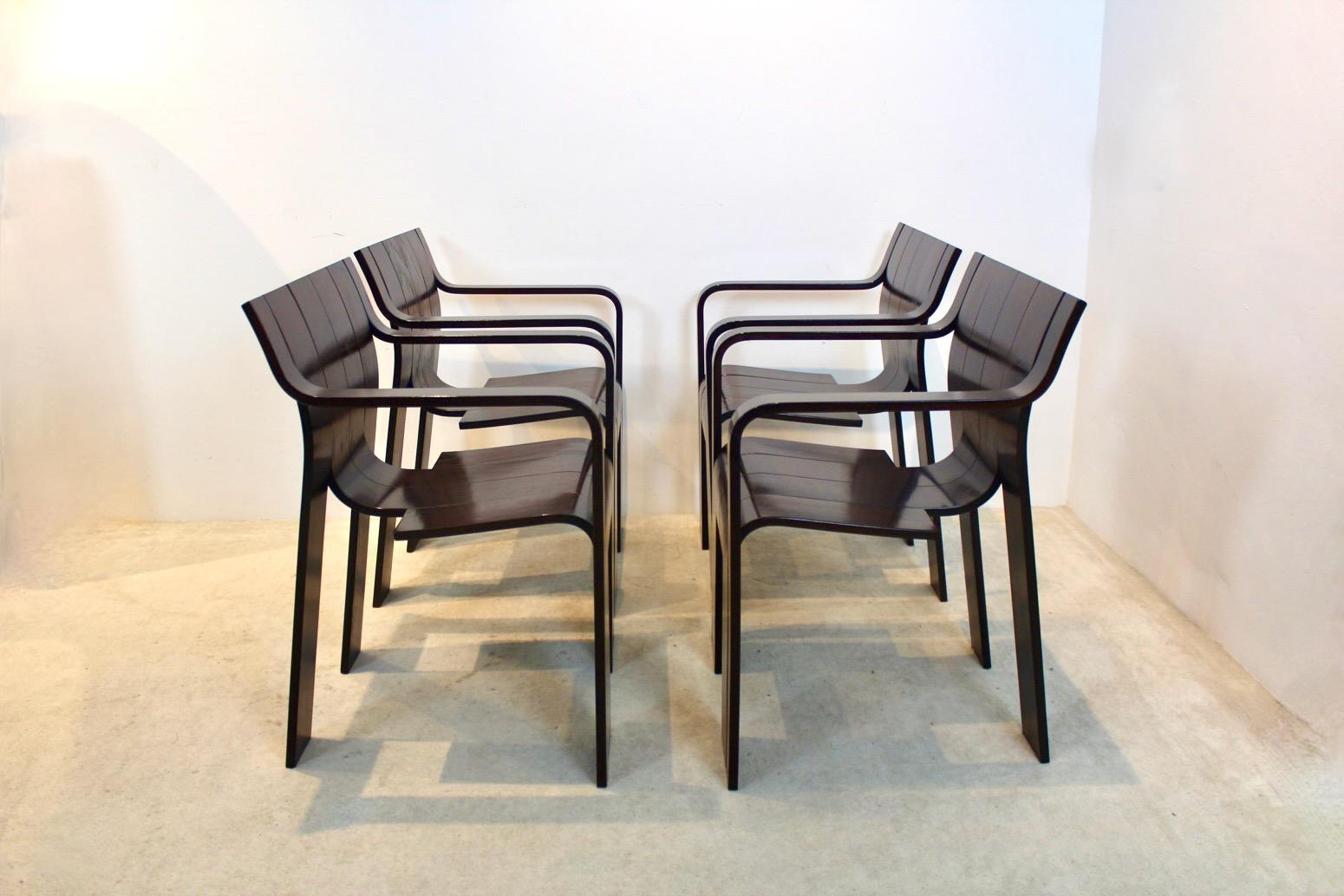 Very rare set of ‘Strip’ dining chairs with armrests, designed in 1974 by Gijs Bakker for Castelijn in the Netherlands (marked). Only a limited amount of these chairs were made with armrests. This inventive design consists of six curved strips that