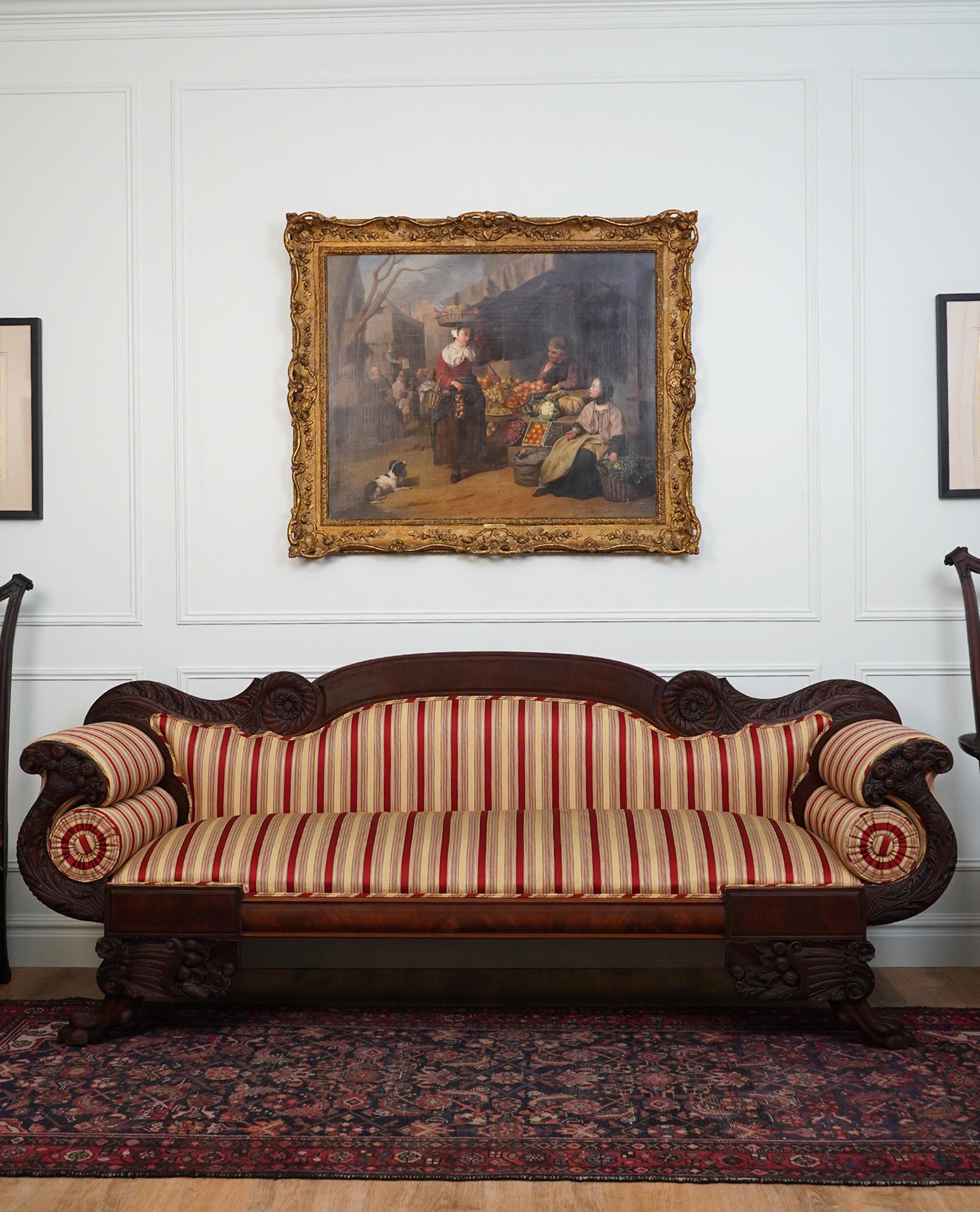 Red and cream striped upholstery is framed by carved scroll arms.

36