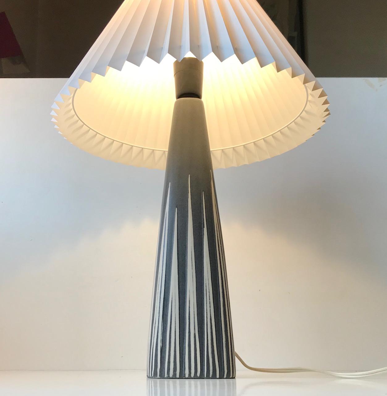 Striped ceramic table lamp designed by Svend Aage Holm-Sørensen. Slate grey main glaze decorated with vertical white stripes. Manufactured by Søholm in Denmark from 1956-1960. Reminiscent in style to Ingrid Atterberg's works for Ekeby. The shade is