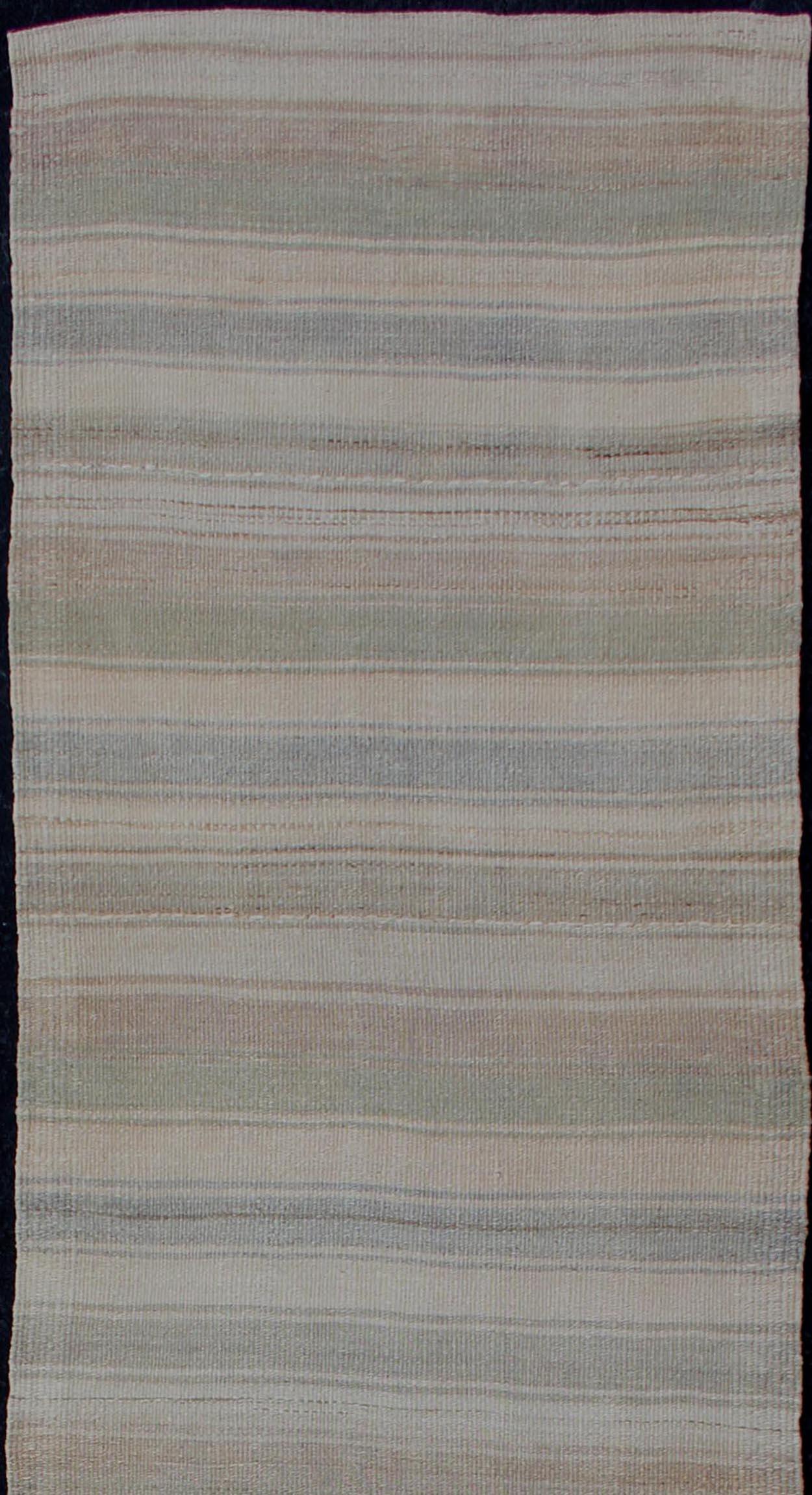 Vintage Kilim runner from Turkey with stripes, rug EN-179933, country of origin / type: Turkey / Kilim, circa 1960

This softly striped-design vintage runner from Turkey features a modern look, rendered in taupe, gray, blue, tan, light brown and