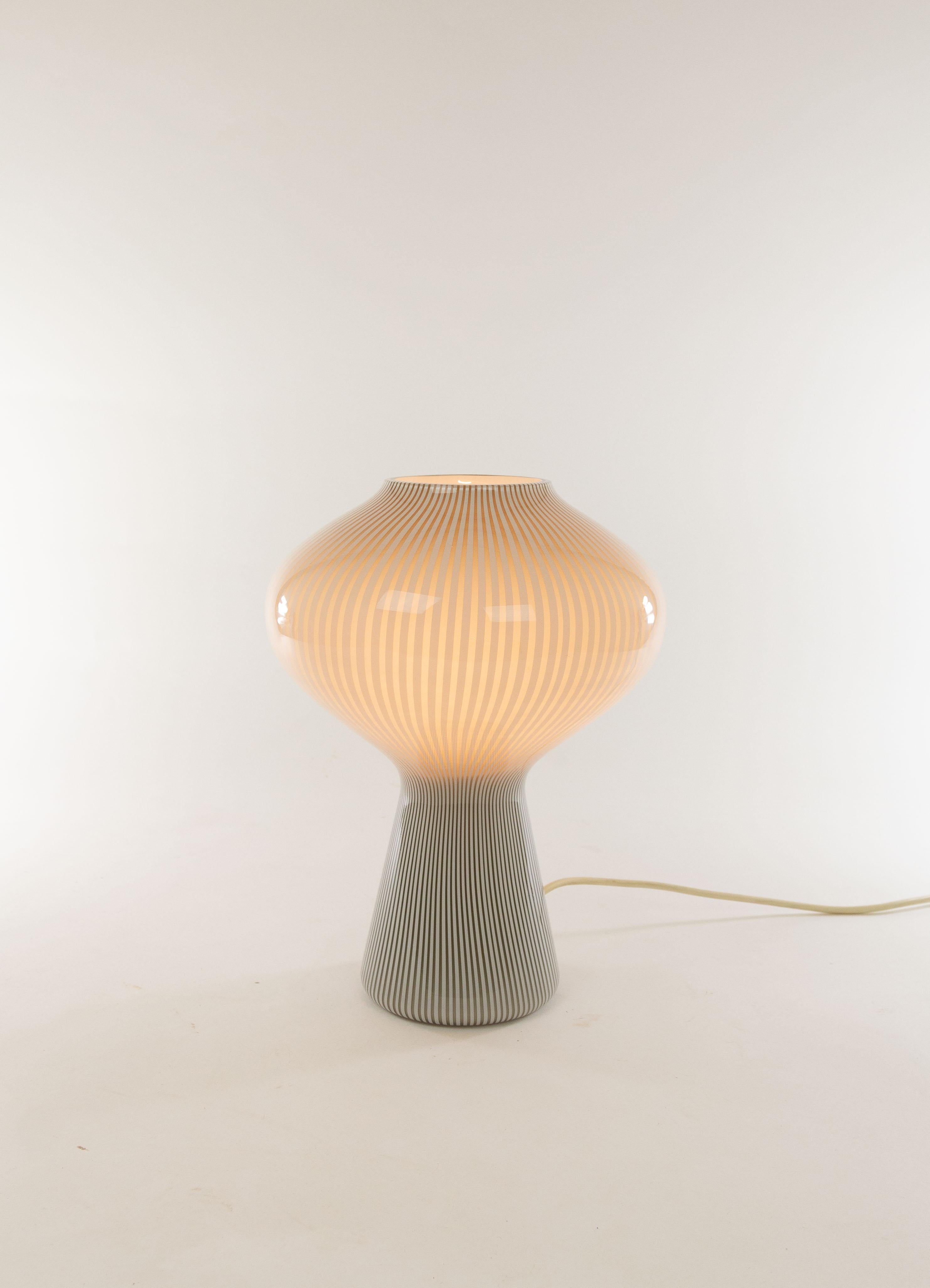 A hand blown grey-white striped glass Fungo table lamp designed by Massimo Vignelli at the start of his impressive career in design and executed by Murano glass specialist Venini. 

This model is produced in three different sizes; this is the