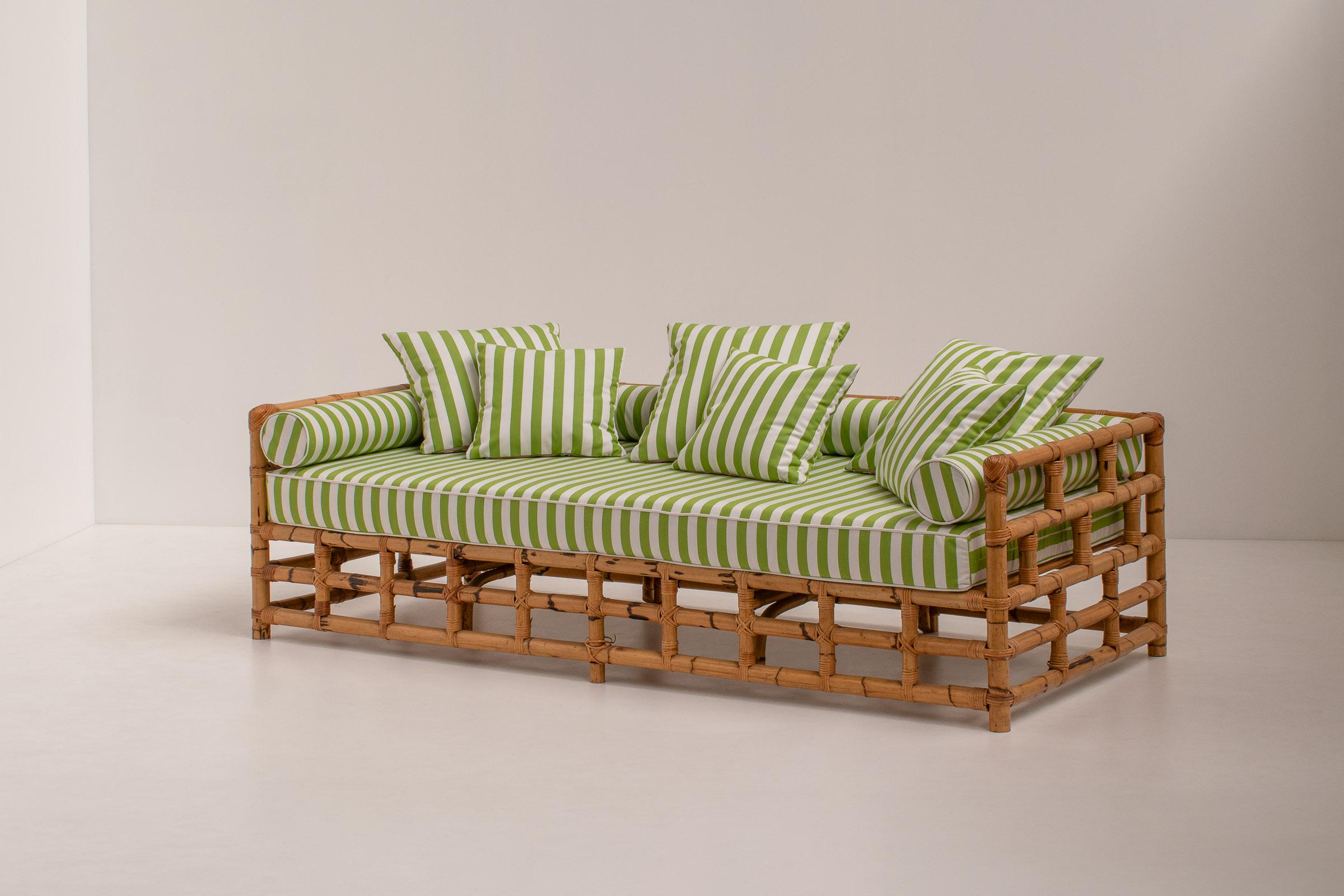 Stunning bamboo daybed or sofa from the 1970s. Sourced in Italy. 

The open structure of the frame gives the sofa a very elegant feel and it makes it look beautiful from any angle. The striped upholstery gives a beautiful, tropical, and fun contrast