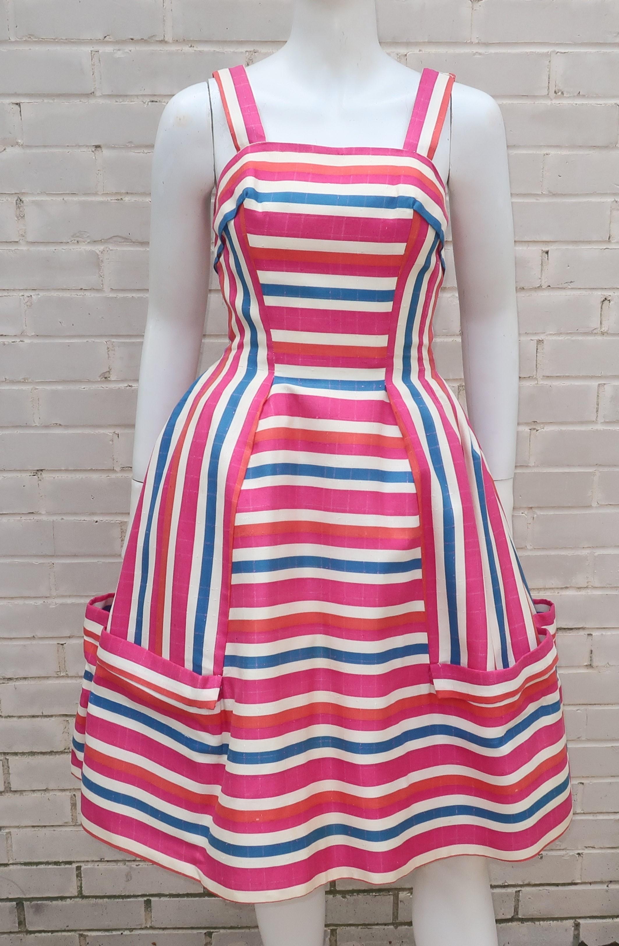 Adorable striped candy confection!  C.1960 party dress in a linen blend heavy striped fabric in shades of hot pink, orangey-red, royal blue and white.  It zips and hooks at the back with acetate lining in the bodice and a netted built-in crinoline