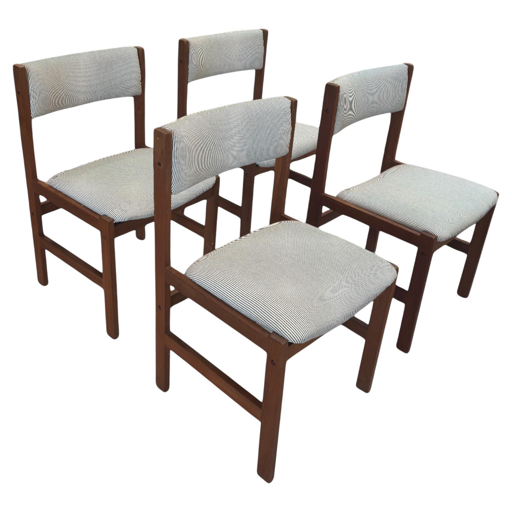 Set of four vintage mid-century dining chairs, beautifully restored and reupholstered in a classic striped fabric. The rich wood frame showcases clean lines and a timeless silhouette, blending elegance with everyday comfort. A perfect addition to