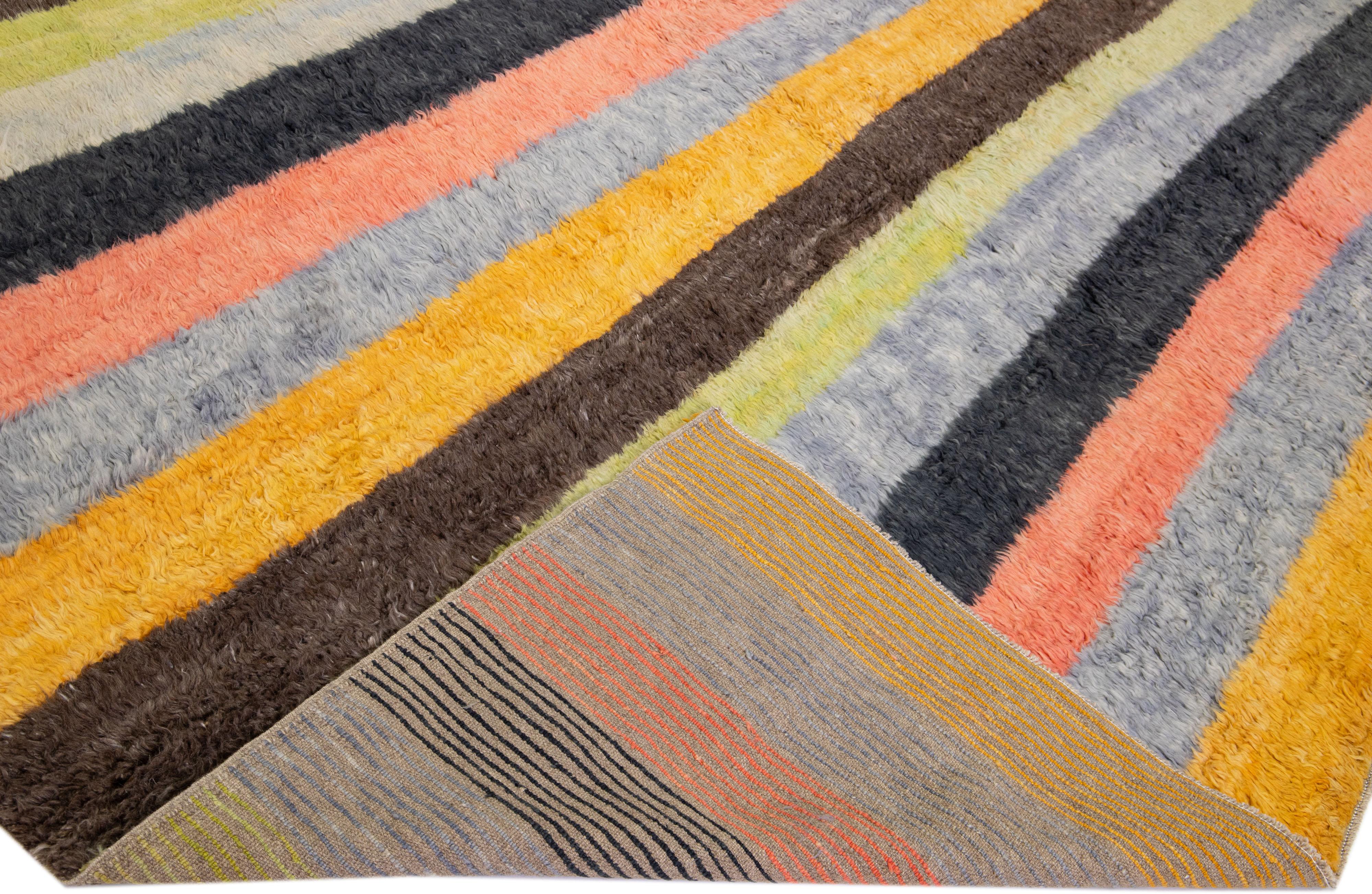 Beautiful modern Tulu hand-knotted wool rug with a multicolor field. This Tulu rug has a gorgeous all-over striped design. 

This rug measures: 13' x 15'.

Our rugs are professional cleaning before shipping.