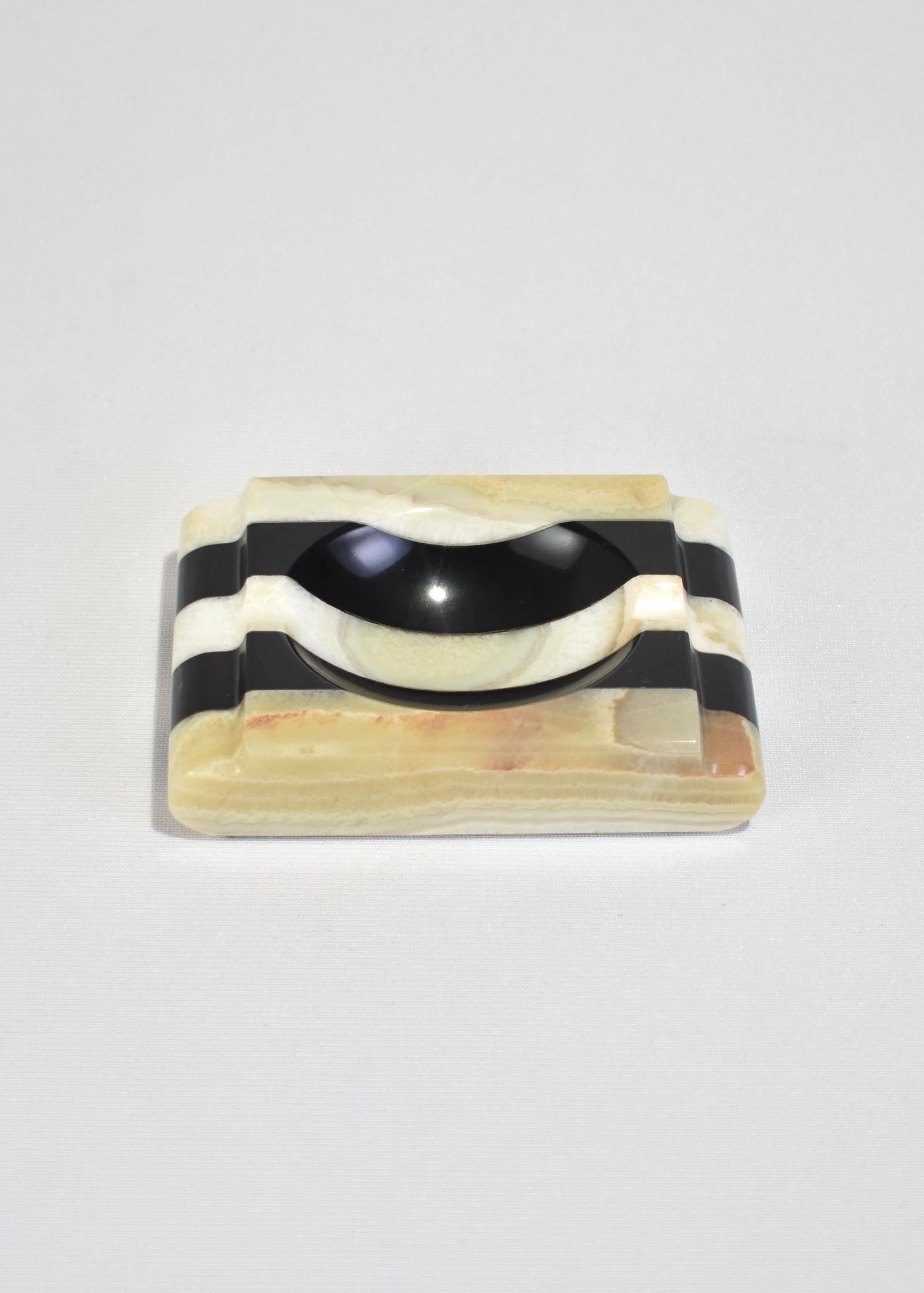 Vintage carved black and white striped onyx catchall or ashtray with a felt base.