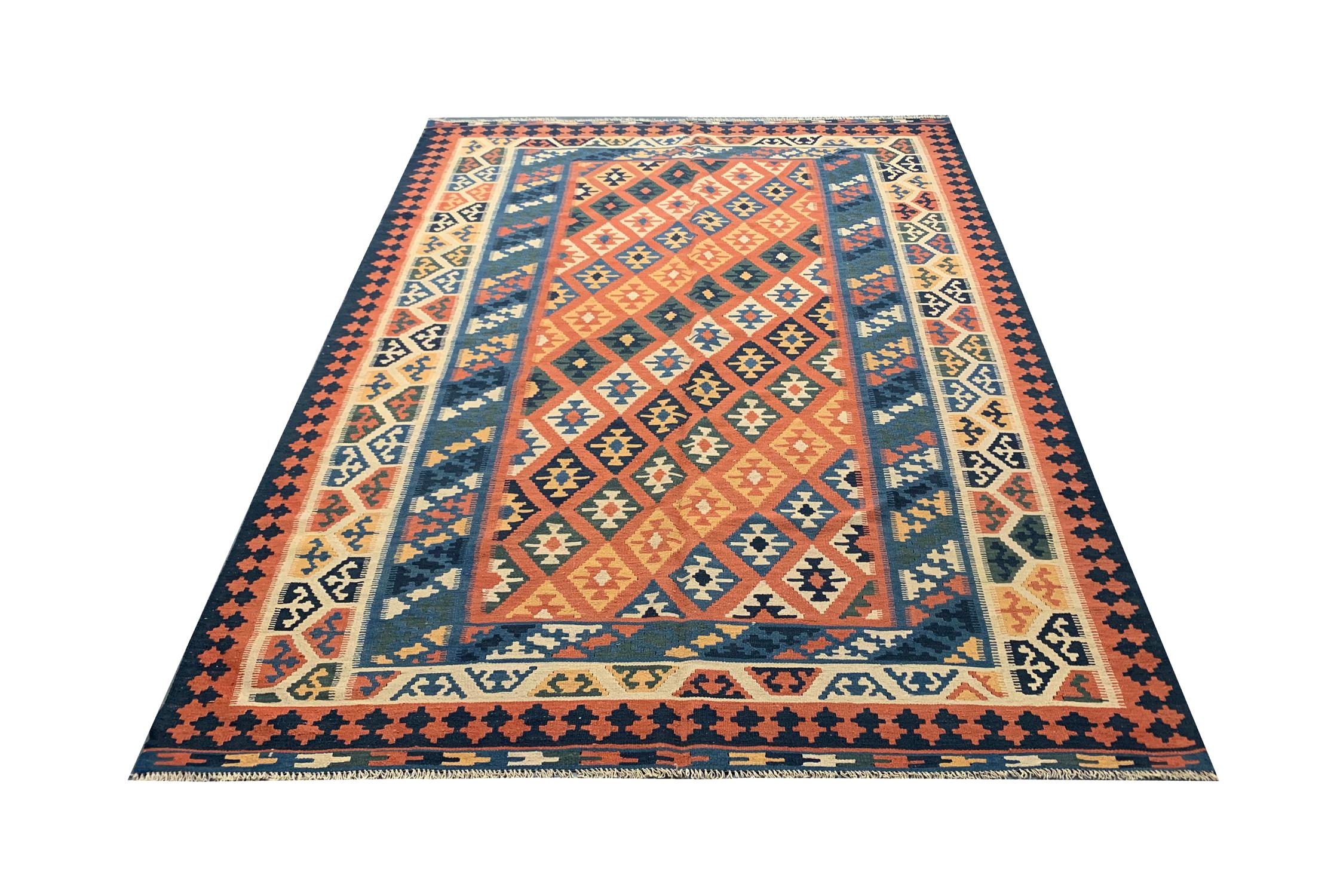 Beautiful vintage Caucasia Kilim rug, woven in the 1960s with a fantastic diamond pattern and multi-layered border. Orange, blue and cream are just some of the vibrant colors included, making it the perfect accent rug constructed with hand-spun wool