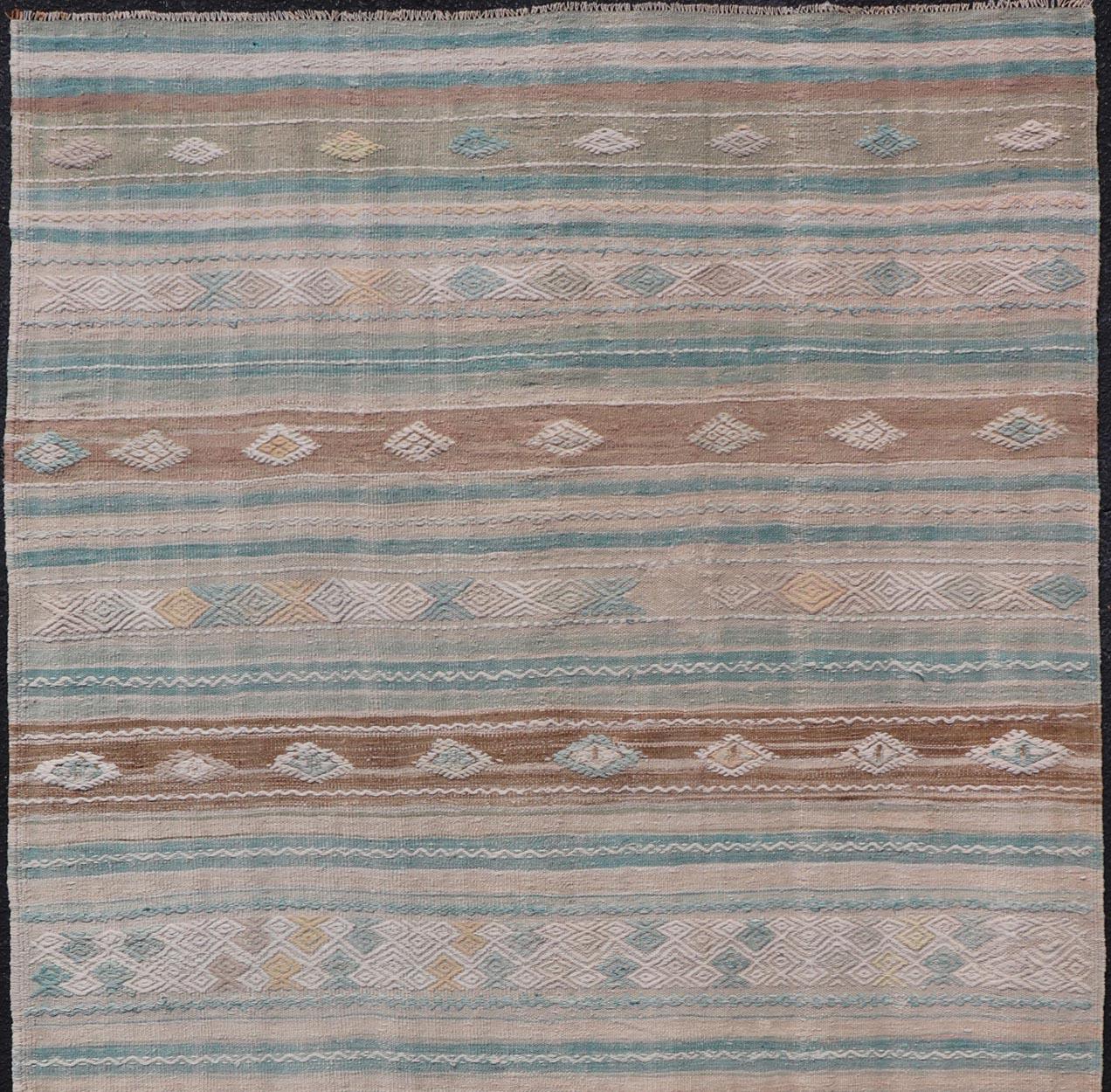 Hand-Woven Striped Turkish Hand Woven Flat-Weave Kilim in Muted Colors and Tribal Motifs For Sale