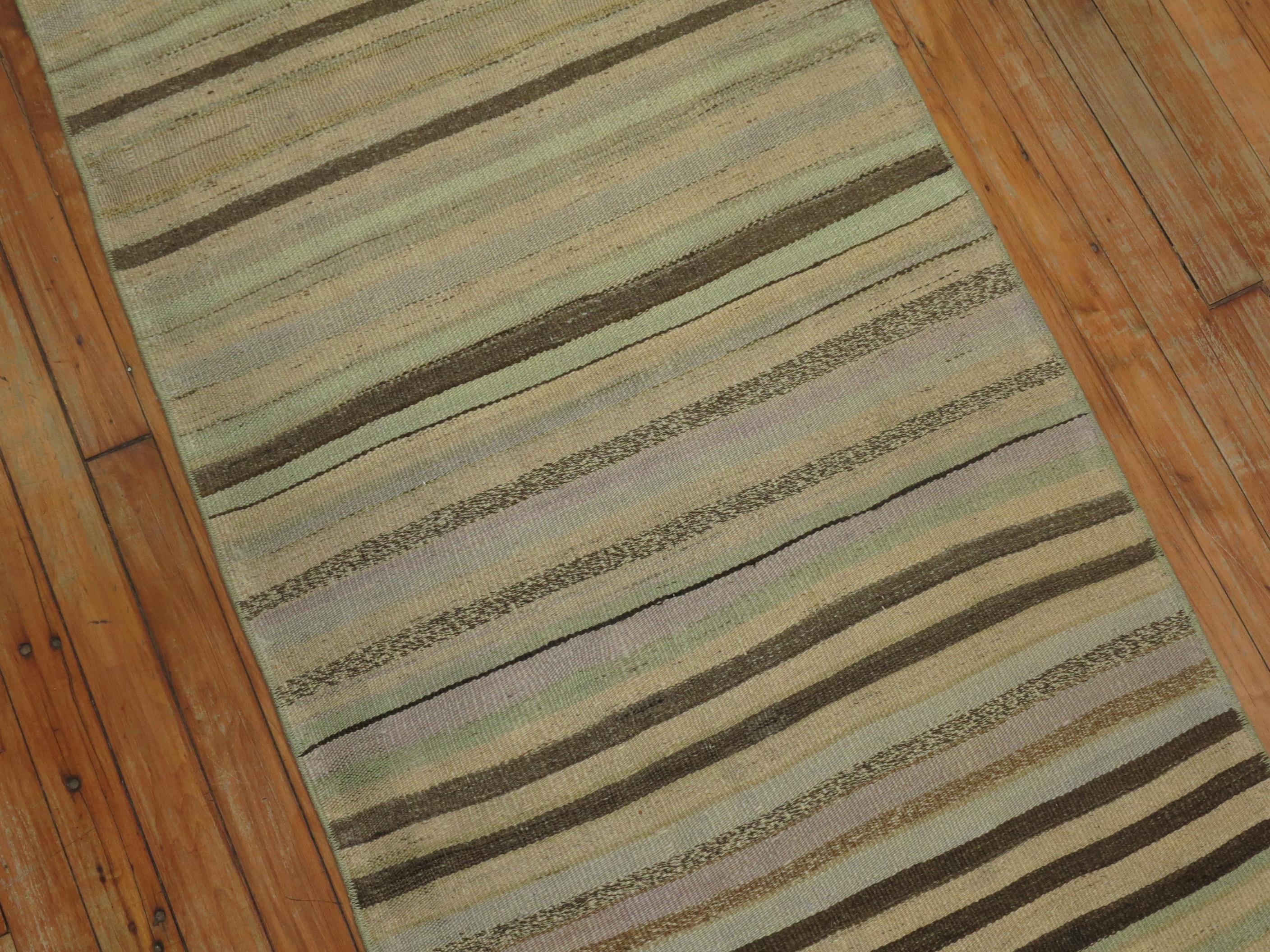 Colorful casual long Kilim runner from the mid-20th century. Mint green, creams, soft blue, lavenders.
Measures: 2'5'' x 24'2''.