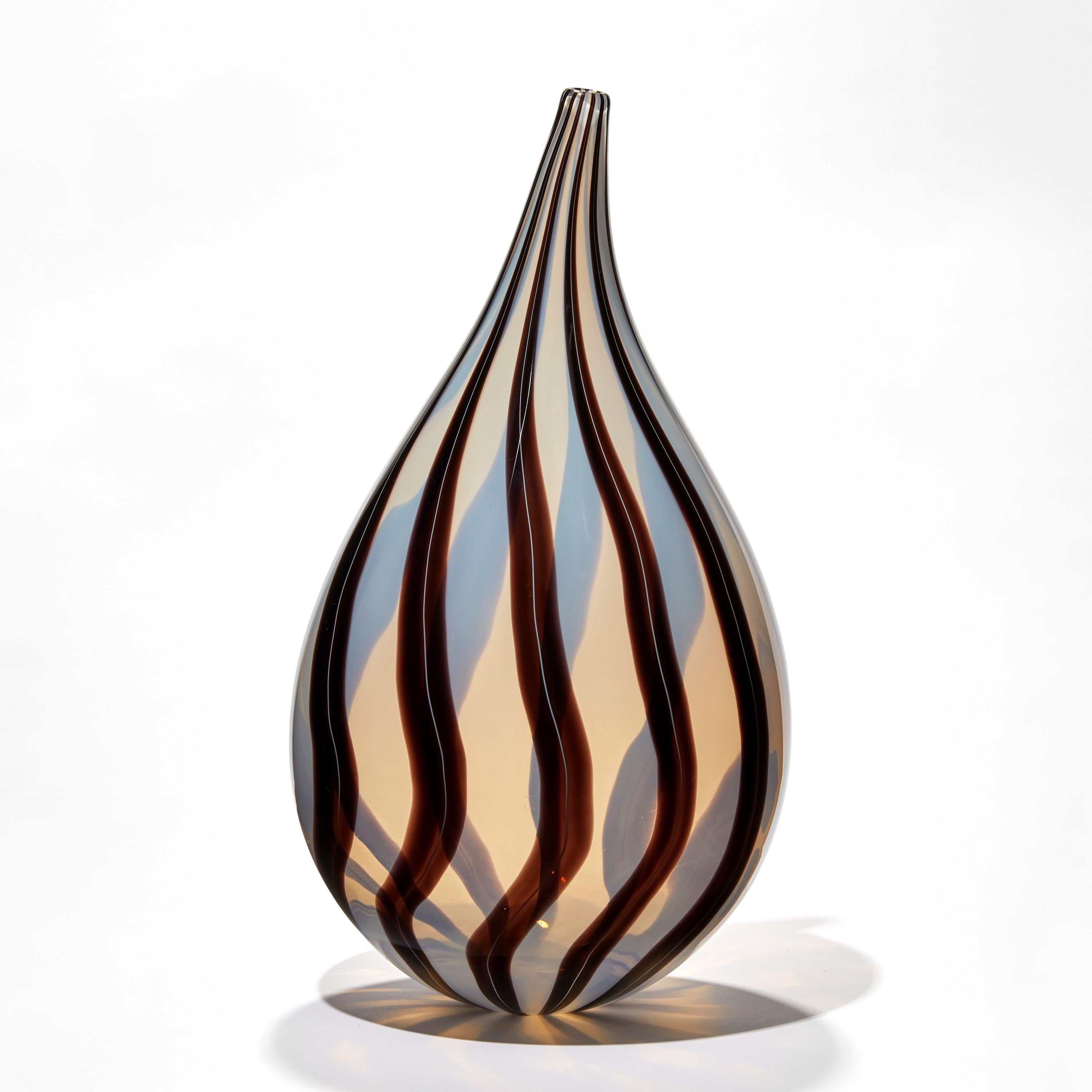 Stripes III is a unique handblown opaque white and dark aubergine glass sculpture by the Swedish artist Ann Wåhlström. Created to form an elegant teardrop shape, finishing in a refined thin neck, canes of dark coloured glass appear woven into the