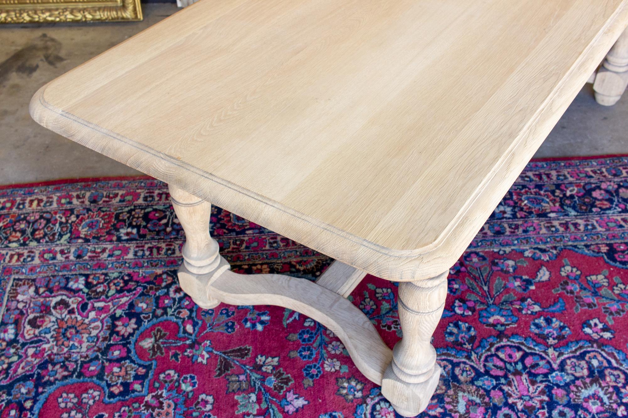 20th Century Stripped Antique French Oak Table with Hand Carved Details and Beveled Edge Top