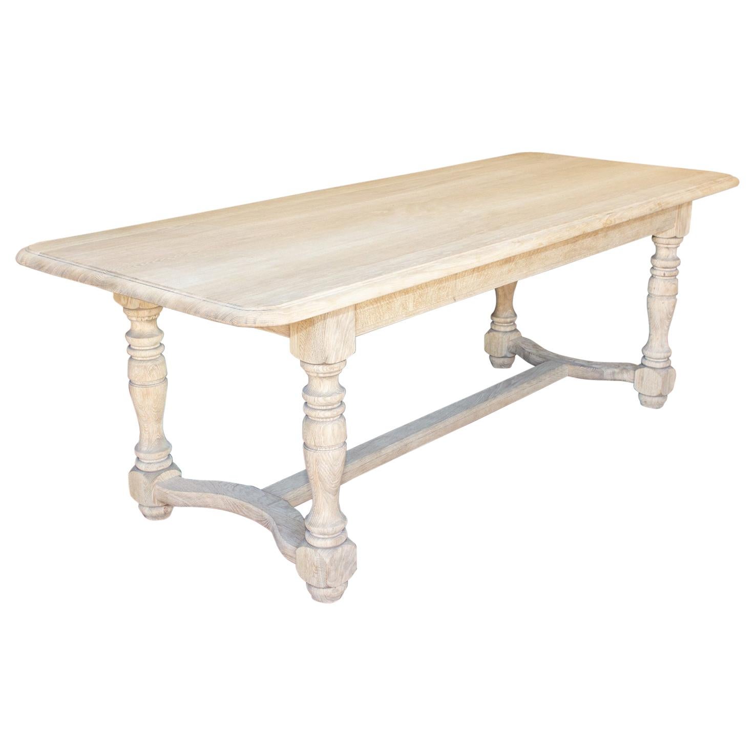 Stripped Antique French Oak Table with Hand Carved Details and Beveled Edge Top