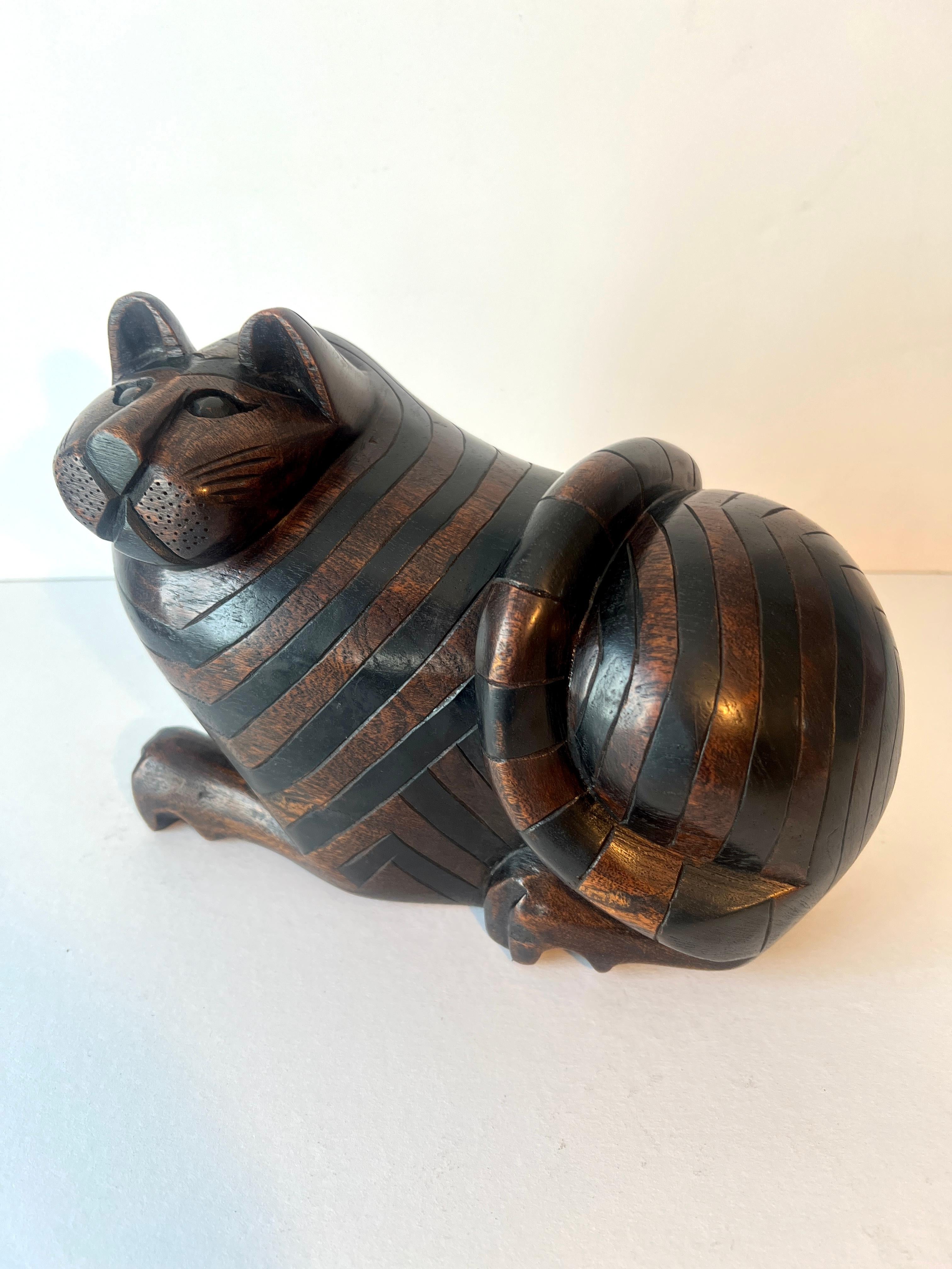 A beautifully crafted and hand-carved Sculpture of a Cat, Stash box.

The large and bulbous cat is stripped and quite handsome, the underside has a removable slide door that can hold anything from cash, to 420 and more.

We love this piece on a side