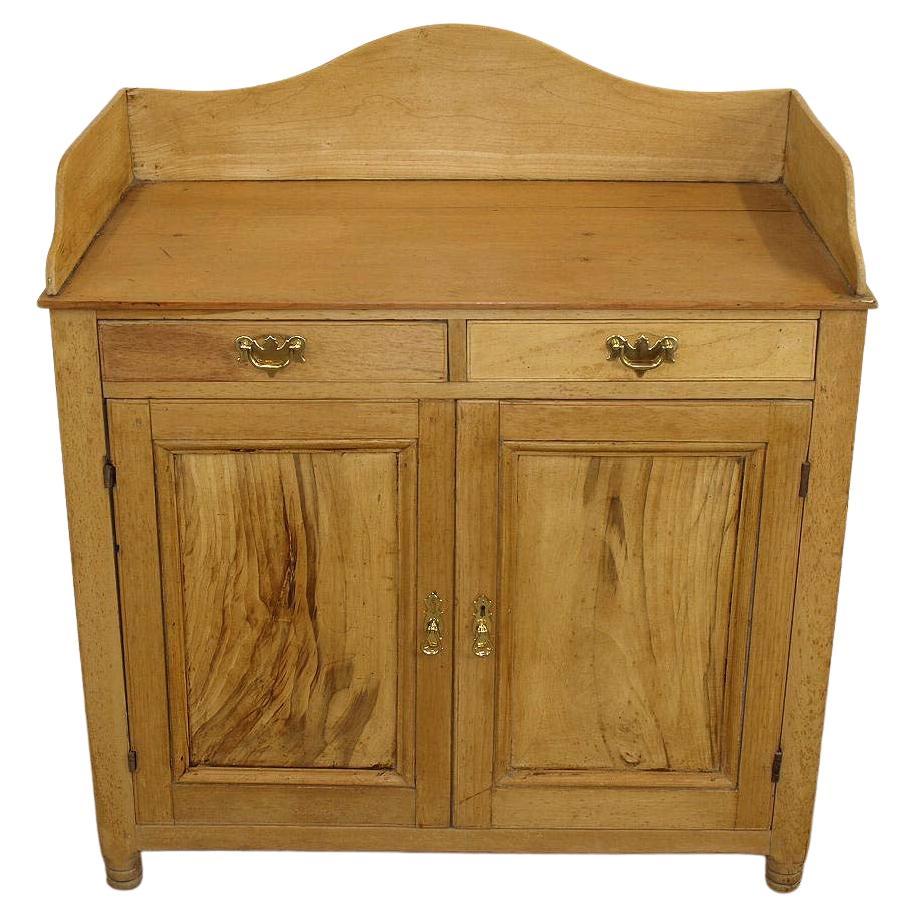 Stripped pine and beech cabinet with gallery surrounding the top, two drawers over the two cabinet doors; the side panels are pine but the drawers fronts and panels in the doors are beech. The door panels have especially beautiful swirl grain. The