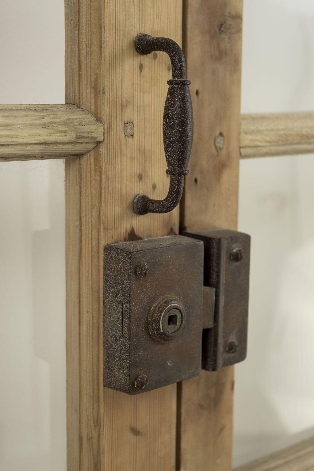 Stripped pine double doors with sidelight windows. 19th century stripped pine doors with upper glass panels. Hand-made and planed with mortise and tenon construction. Hinged in iron with nice steel and brass hardware. Some glass missing. Sold as is.