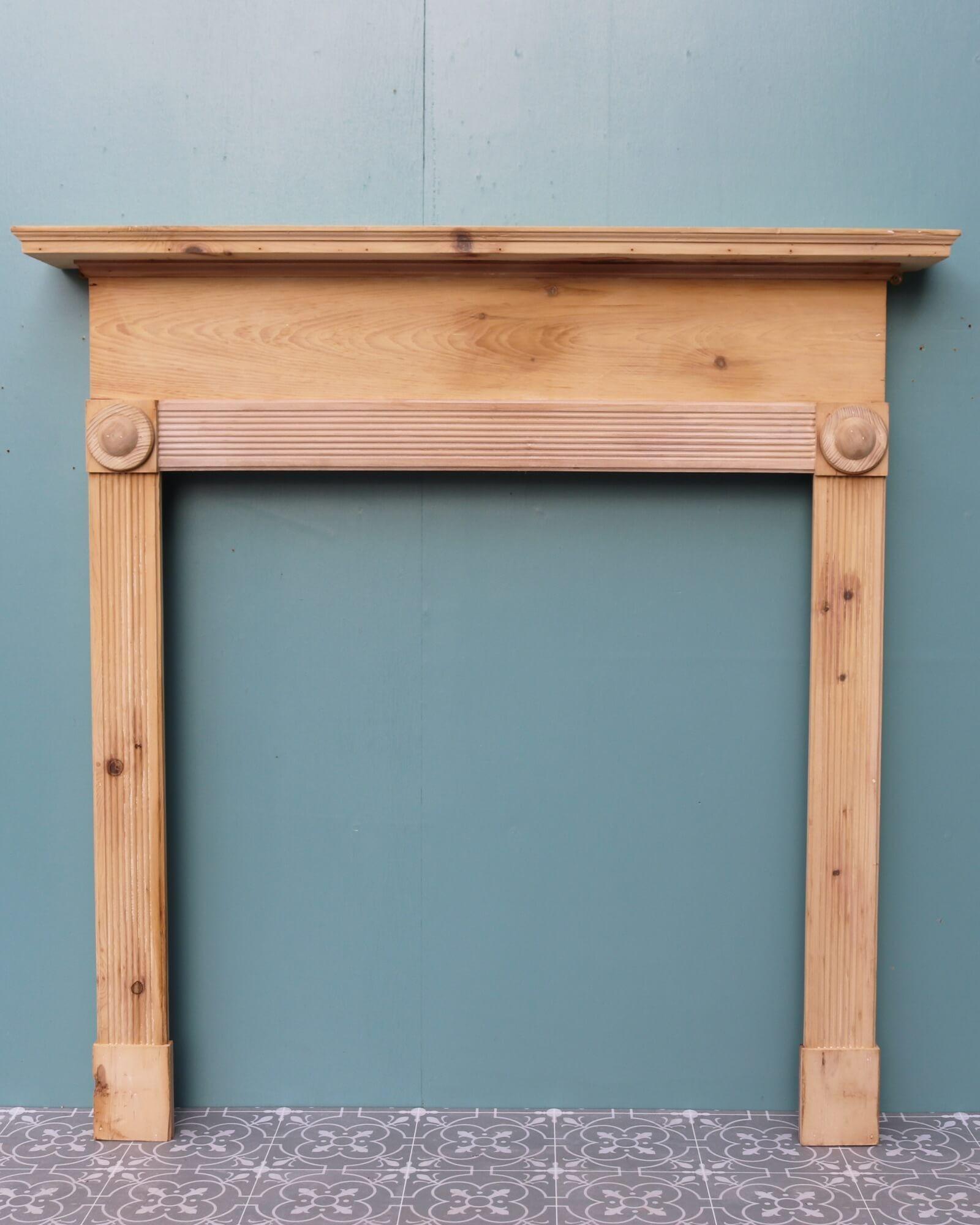 Though this antique English fireplace dates from the cusp of the 20th century, its design draws influence from bullseye fireplaces of the earlier Regency and Georgian periods. Crafted in pine, it is stripped, sanded and ready for finishing in a