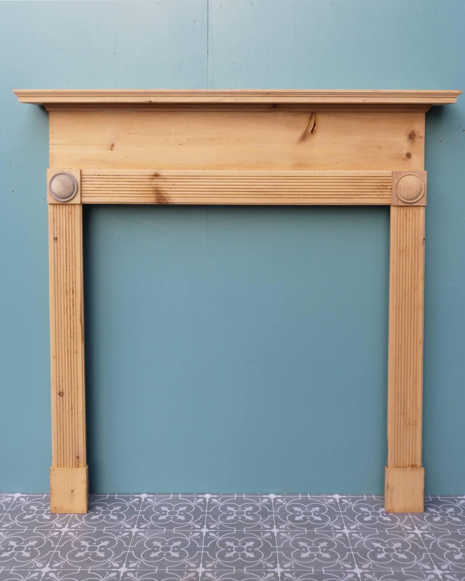 Though this antique English fireplace dates from the cusp of the 20th century, its design draws influence from bullseye fireplaces of the earlier Georgian and Regency periods. Crafted in pine, it is stripped, sanded and ready for finishing in a