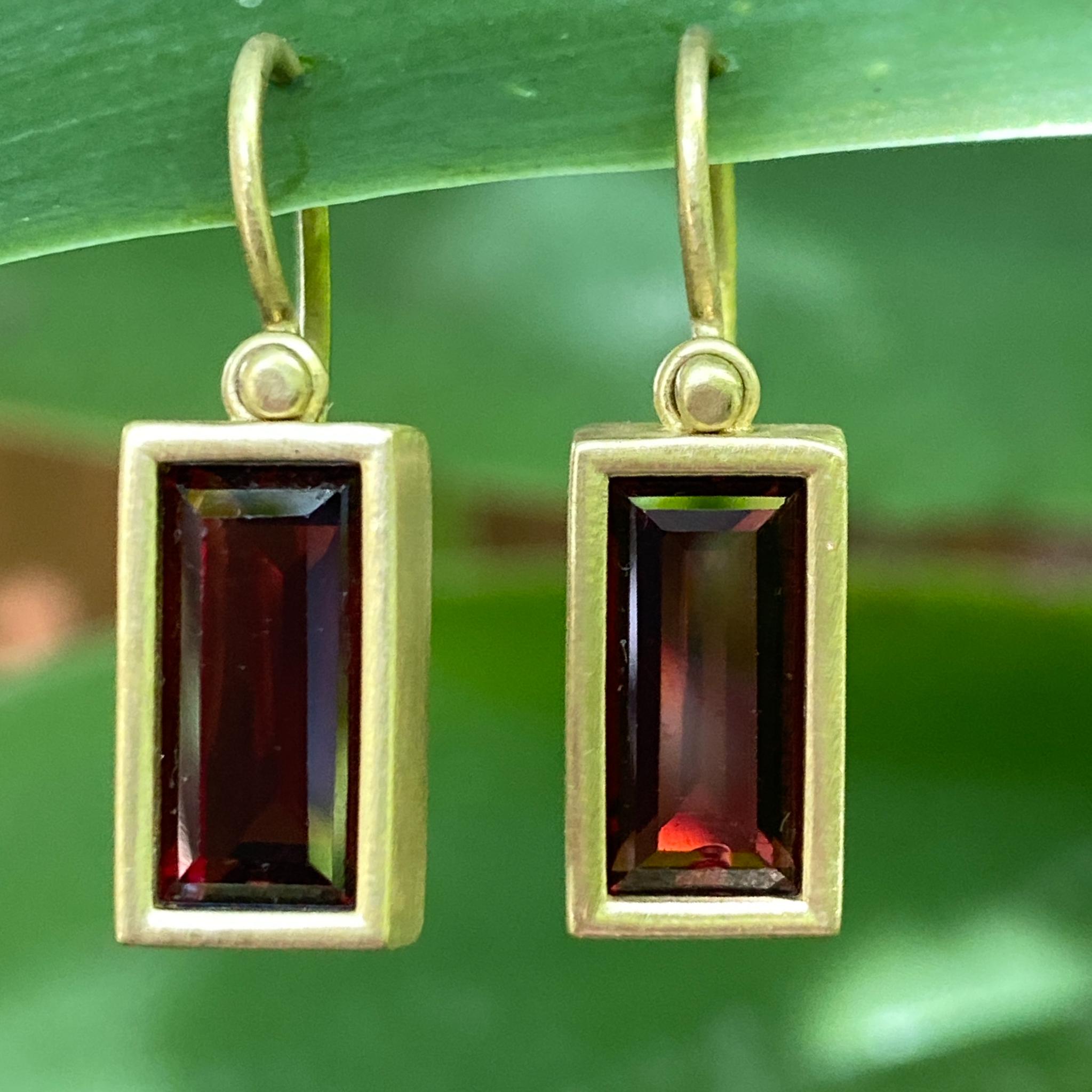 These clean, graphic earrings by Eytan Brandes feature a pair of red garnets in satiny 18 karat yellow boxes on simple wire hooks.

The Zambian garnets are clean step-cut rectangles measuring 12mm x 6mm and weighing 2.9 carats each.  They are