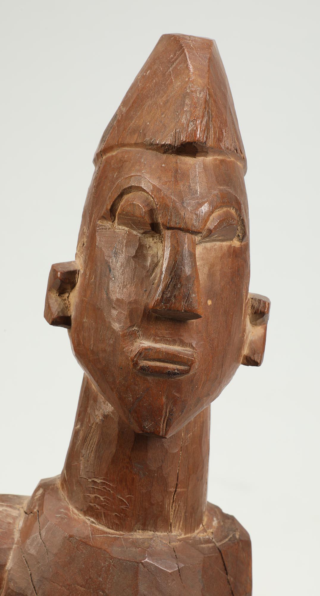 Finely carved large geometric figure from the Lobi, of Ghana and Burkina Faso, dating from the early to mid-20th century. It has a captivating intense gaze and one arm folded on chest, and other arm out to the side. Carved from very hard wood, Some