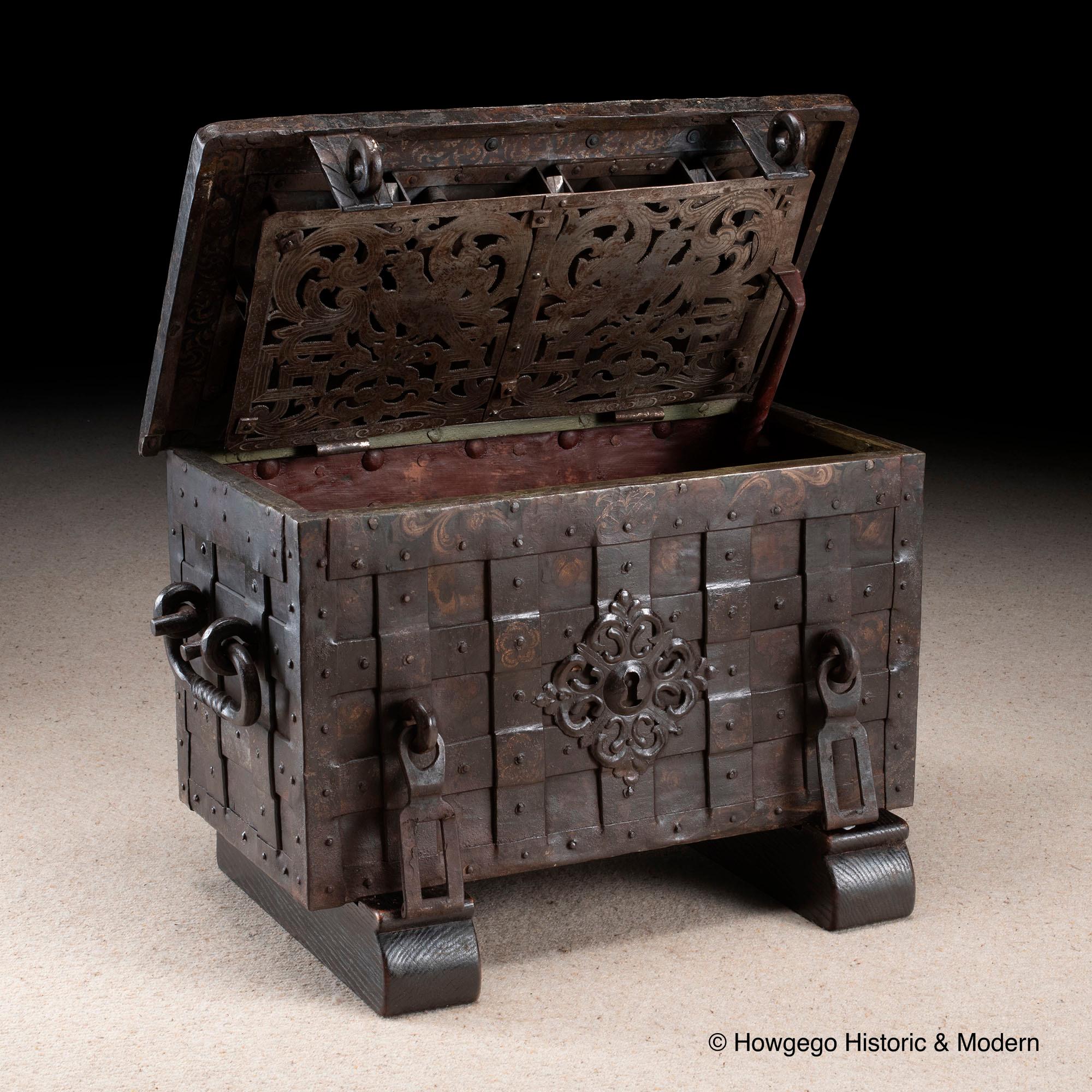 Rare, small, late-Renaissance, Nuremberg, iron, 'armada box', strongbox or travelling safe with its original, naïve, painted decoration on later sledge feet

This is a rare, small, example of these characterful, early models of transportable safes.