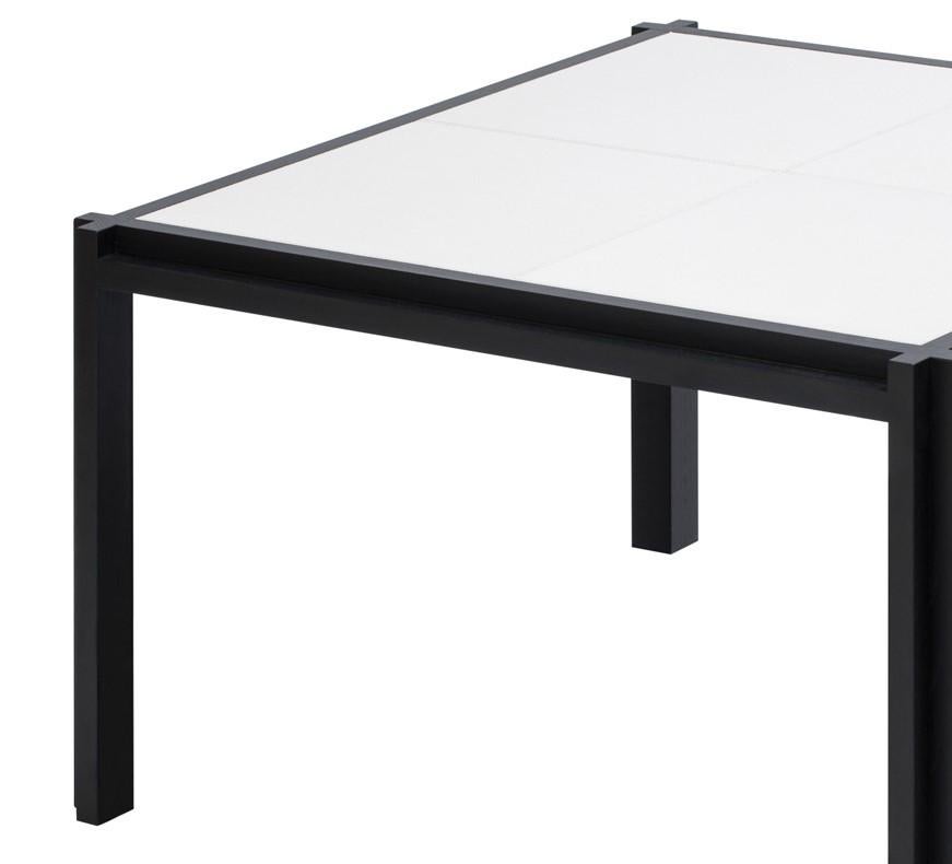 This versatile and sophisticated coffee table is a precious addition to a contemporary interior, where it will provide a display surface and a striking decorative accent with contrasting black and white color combination. The L-shaped cross section