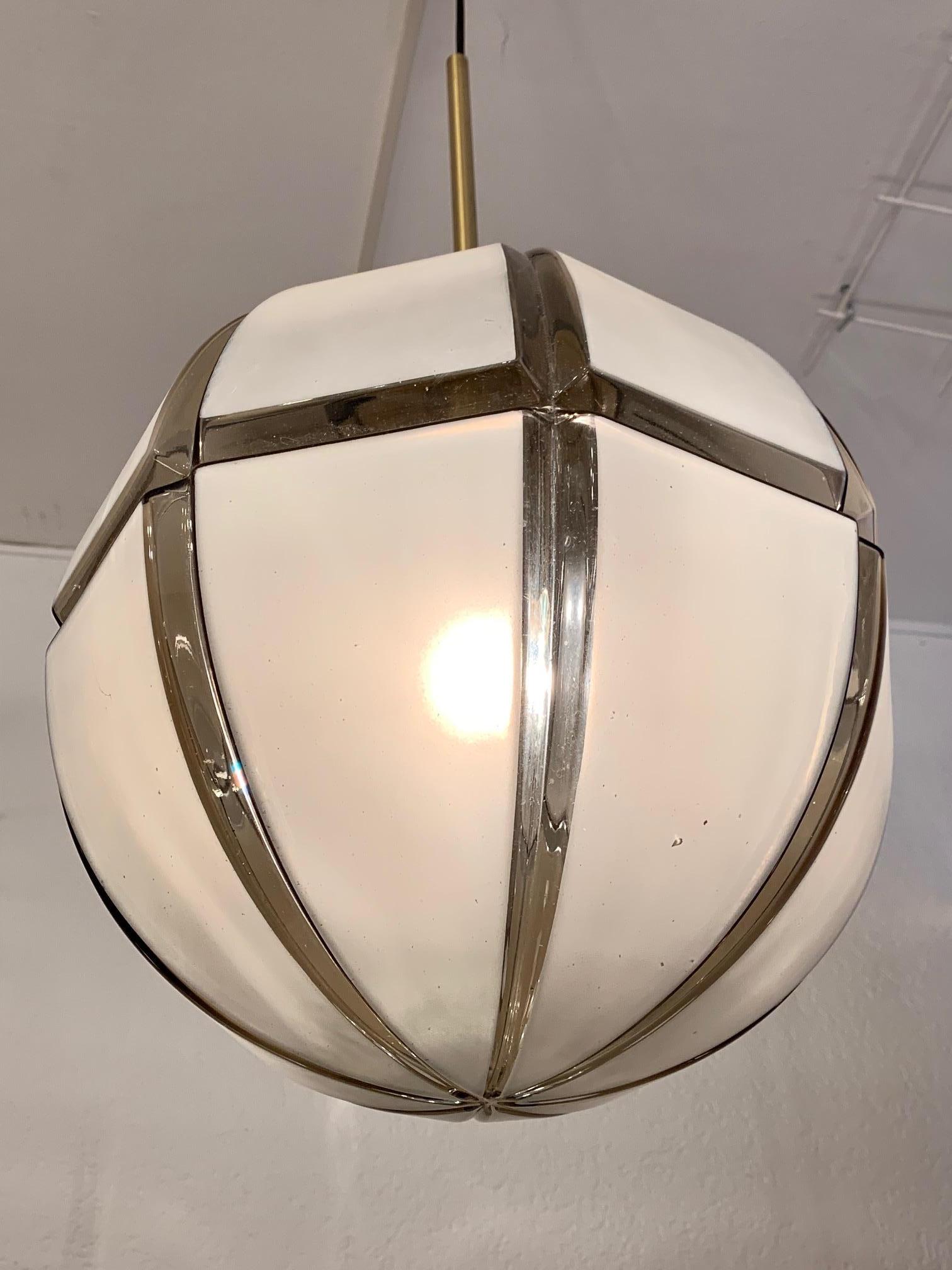 Structured smoked glass pendant lamp by Limburg, Germany ca. 1970's
Brass fixture
.