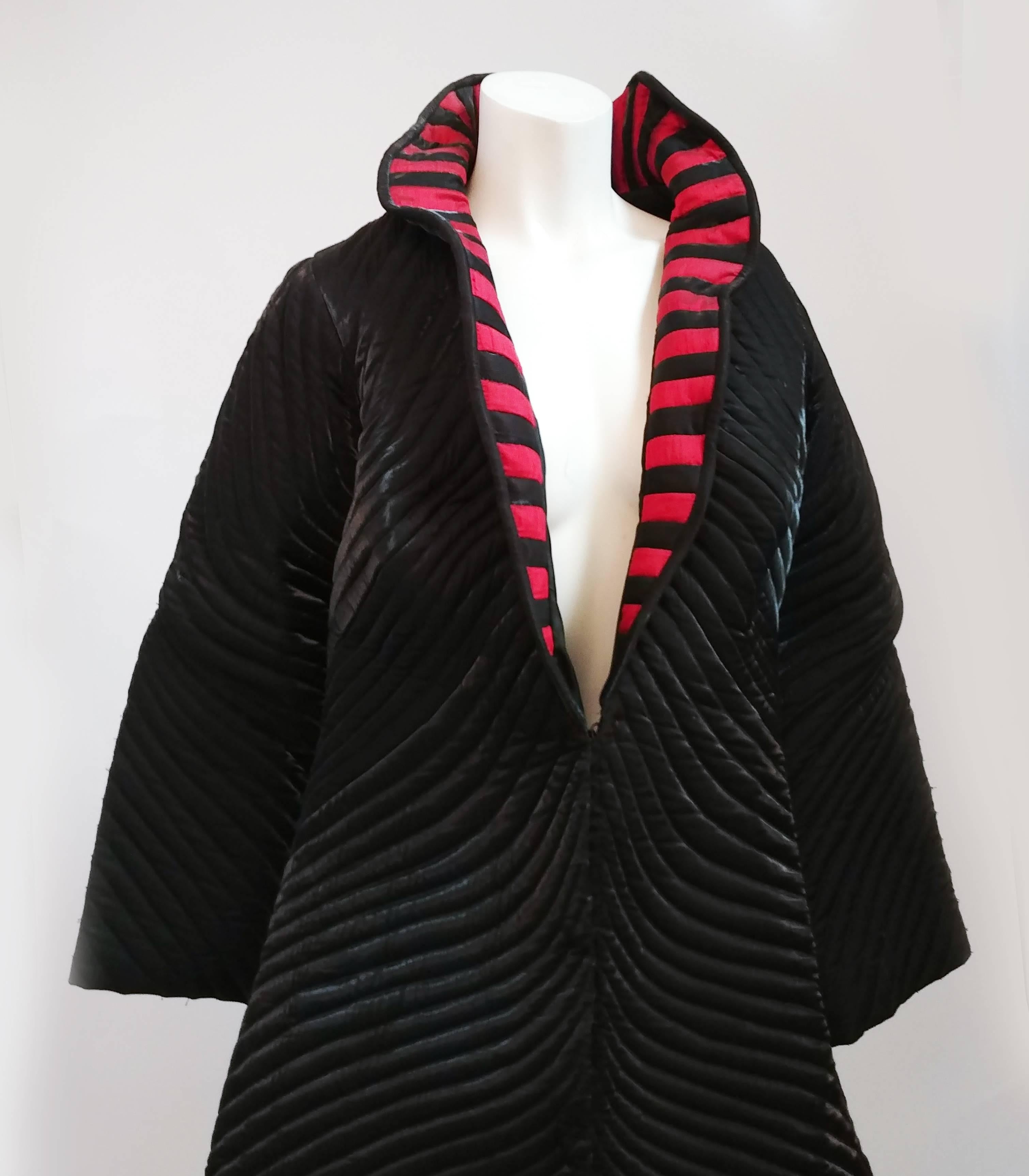 Structured Quilted Stripe Coat, 1980s. Quilted theatrical coat with red and black stripped wired standup collar. Large snap front closures.