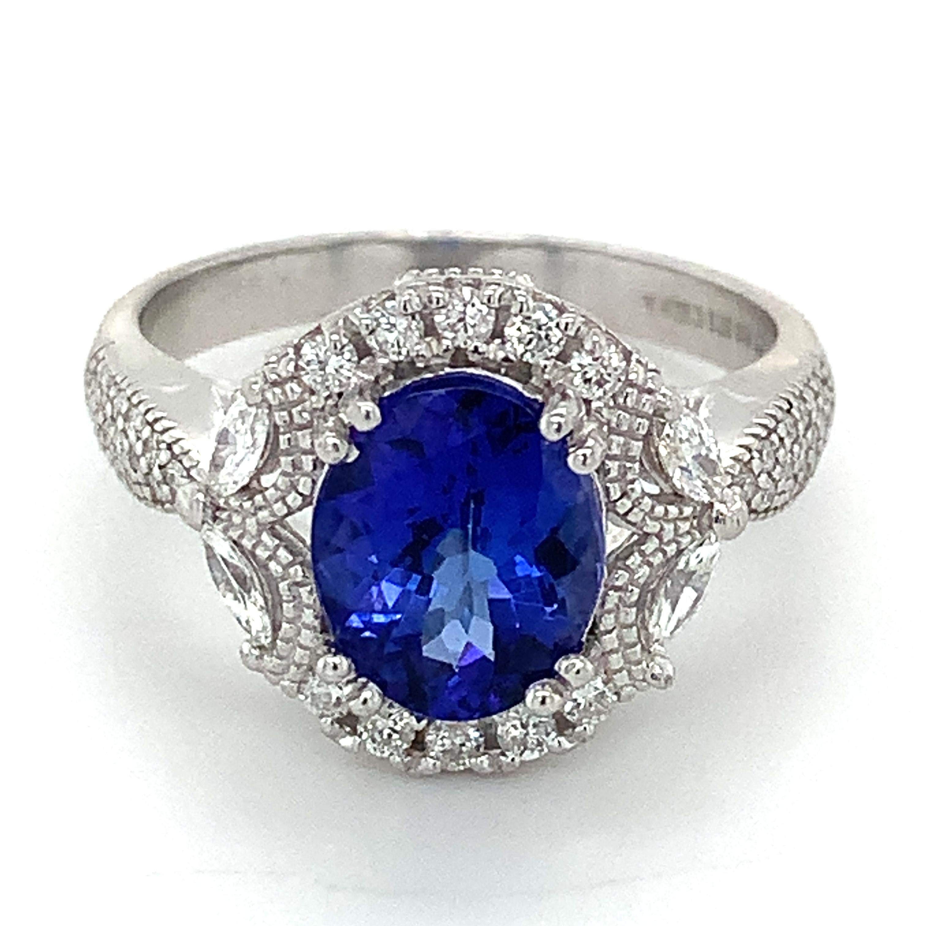 Platinum Oval Cut Tanzanite And White Marquise & Round Diamond Ring
Ring Size 9.25
8.8 Grams 
Round & Marquise White Brilliant Cut Diamonds 0.5 Carats Total Weight
Clarity: Si Color: F-H
1 Oval Cut Tanzanite 10x8mm
This is a flawless tanzanite ring.