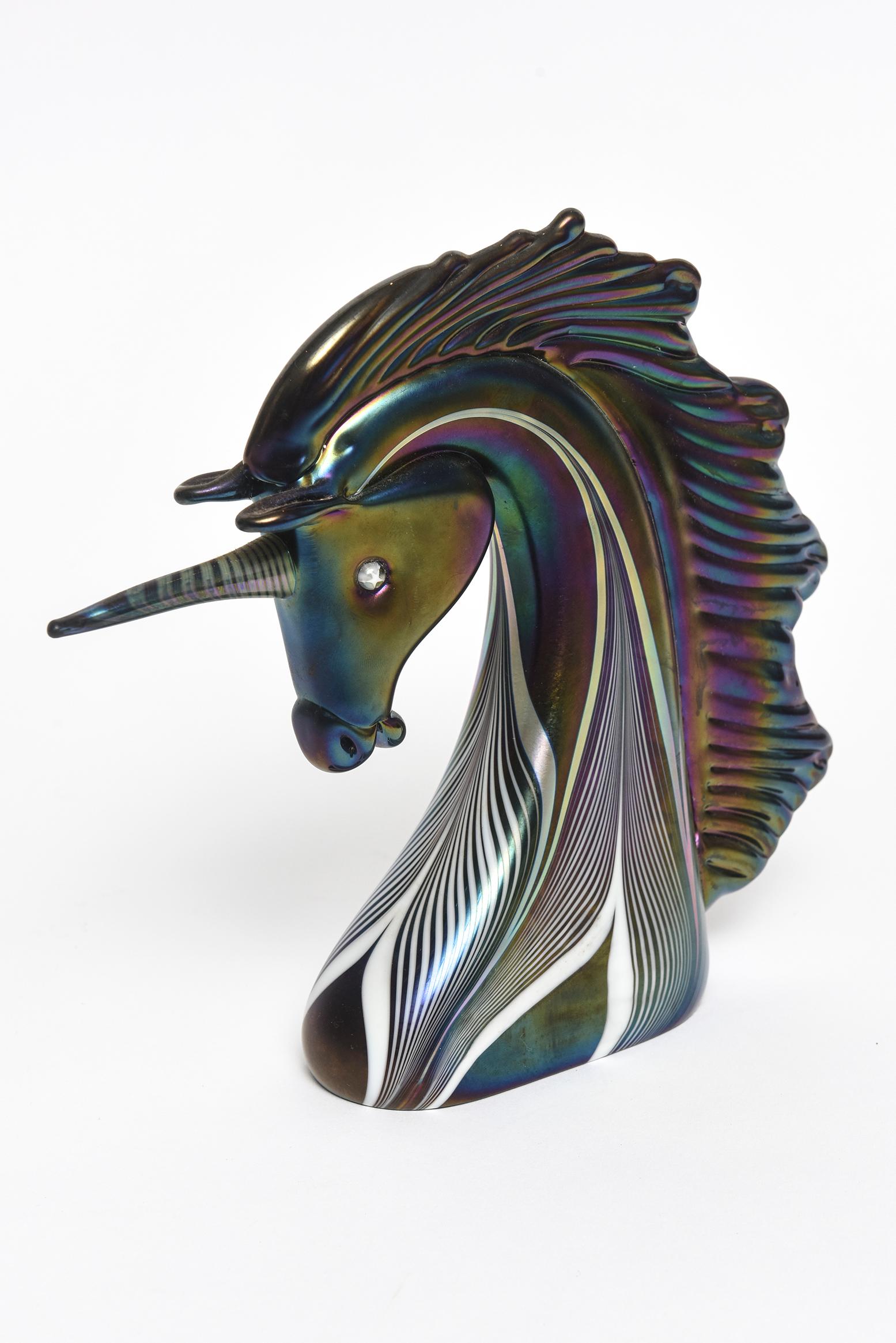 Beautiful art glass unicorn bust by Stuart Abelman featuring a pulled feather iridescent design. Signed on the bottom. Date 1985 Number 859

Artist Bio from his site:
Stuart Abelman’s artistic ability was recognized at an early age, giving him
