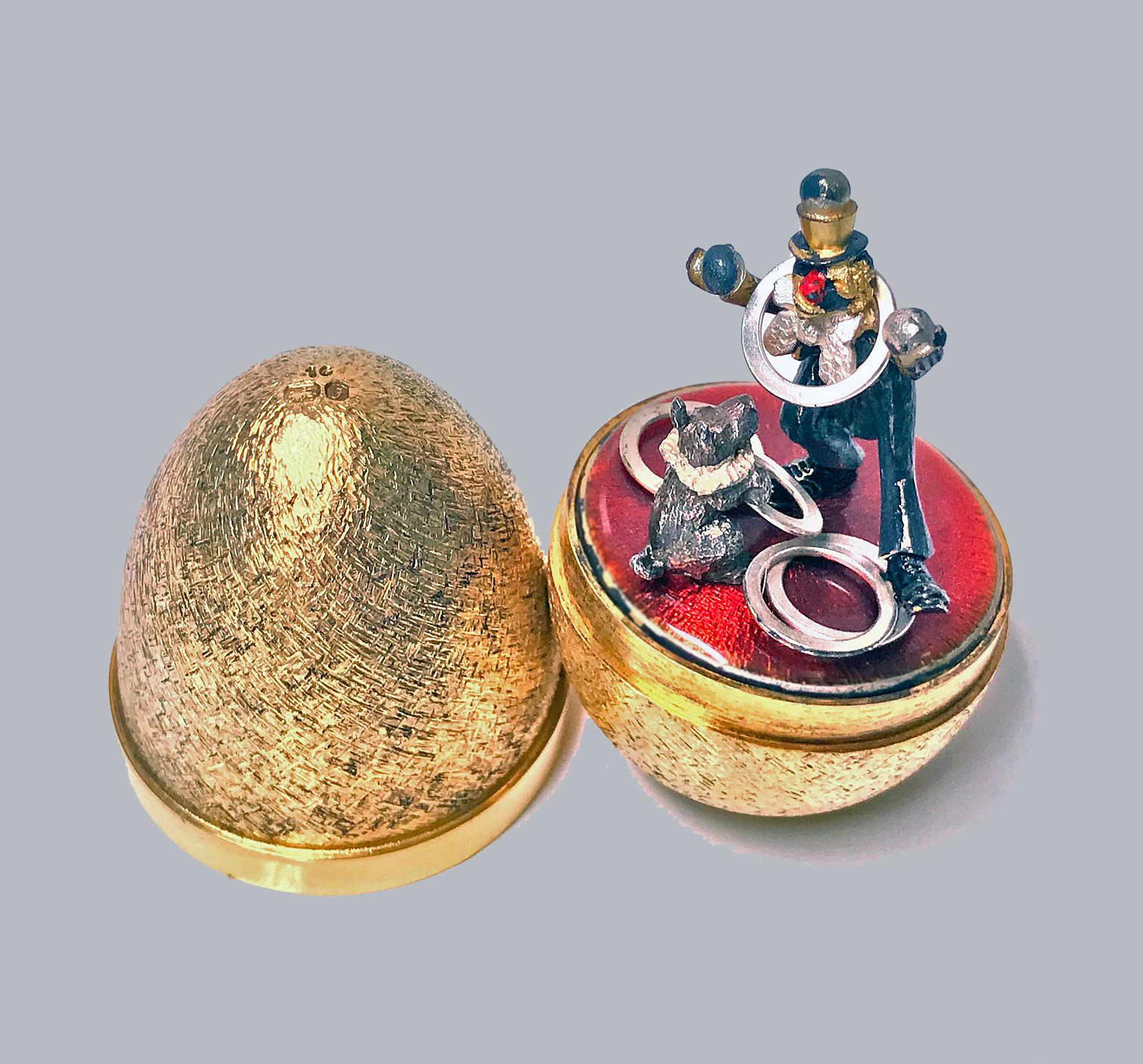 Stuart Devlin silver gilt surprise egg, London 1980, opening to reveal a clown and performing dog. Original box and papers. Height: 7.5cm high, No 19 of limited edition of 100. Item Weight: 131 grams.