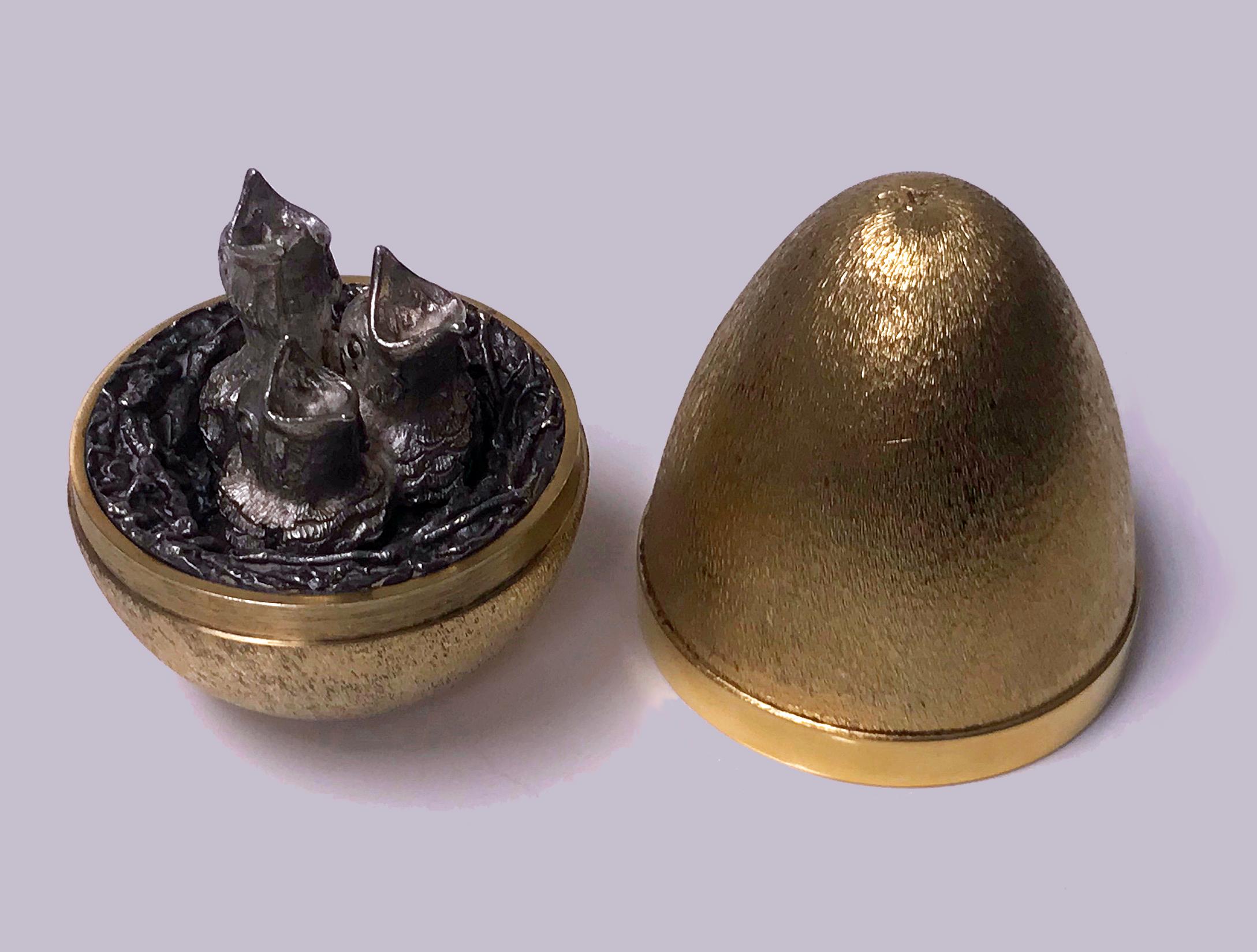 Stuart Devlin silver gilt surprise egg, London 1973, opening to reveal three hatchlings (chicks) in a nest. Original box and papers. Height: 7.5cm high, No 56 of limited edition of 100. Item weight: 162 grams.