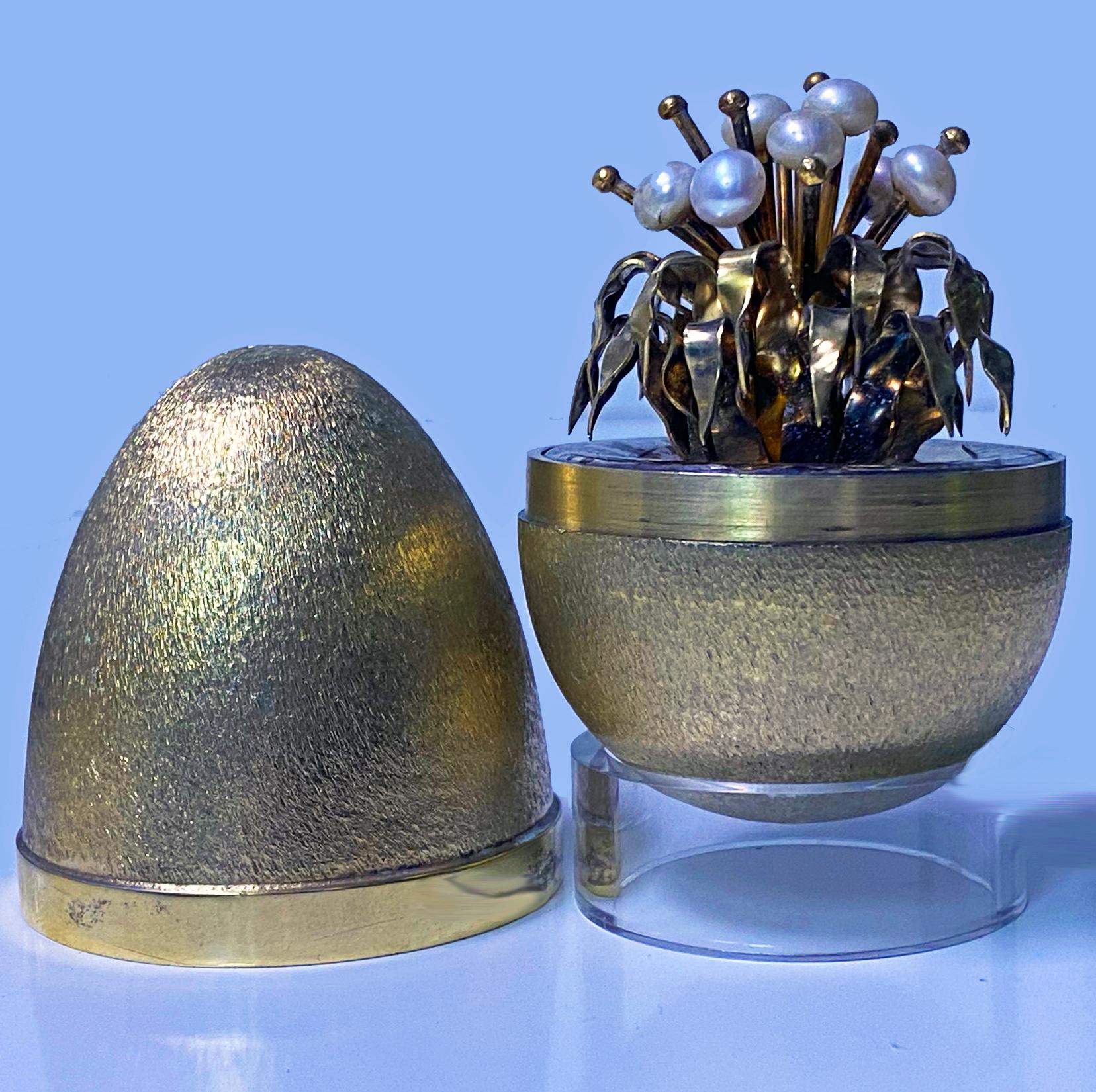 Stuart Devlin Silver Gilt Surprise Egg, London 1977, the top lifts off to reveal a plant with cascading gilded silver leaves and pearl flower heads and stamens. full hallmarks and Numbered 19 of a 100 that were produced. Height: 7.5 cm. Item Weight: