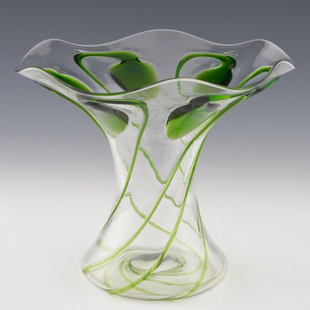 Heading : Stuart for Liberty green trailed 'tadpole' vase
Date : c1910
Origin : Stourbridge, England 
Bowl Features : Applied green trailing
Marks : None 
Type : Lead 
Size : 18cm height, 20.8cm diameter at widest point 
Condition :