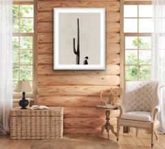 Cowboy by Stuart Redler.  Black and white photo of cowboy with a saguaro cactus