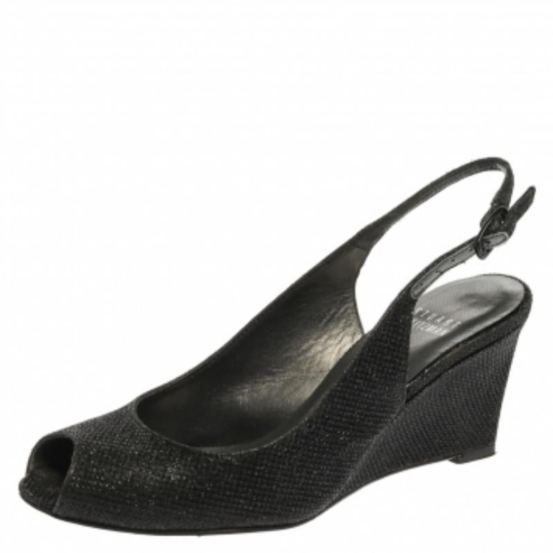 These lovely Stuart Weitzman sandals will bring you the right amount of style and shine. They are made from glittery fabric and designed with peep toes, slingbacks, and 7 cm wedge heels. They are pretty and easy to flaunt.