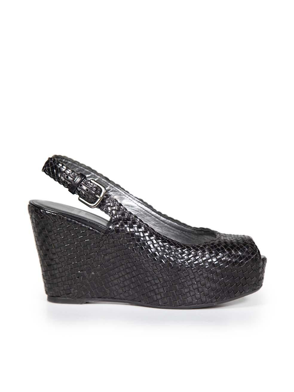 CONDITION is Very good. Minimal wear to the heels is evident. Abrasion to both insoles. Inconsistency to the weave at the top of both heels on this used Stuart Weitzman designer resale item.
 

 Details
 

 

 Black
 

 Leather
 

 Sandals
 

 Peep