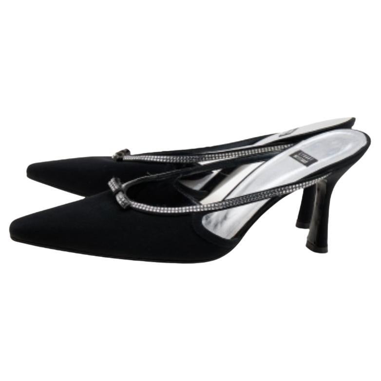 Designed with pointed toes and crystal-embellished fronts, these Stuart Weitzman mules are truly divine! They've been beautifully crafted from fine materials in a classic black hue. They are endowed with leather-lined insoles along with 9 cm heels