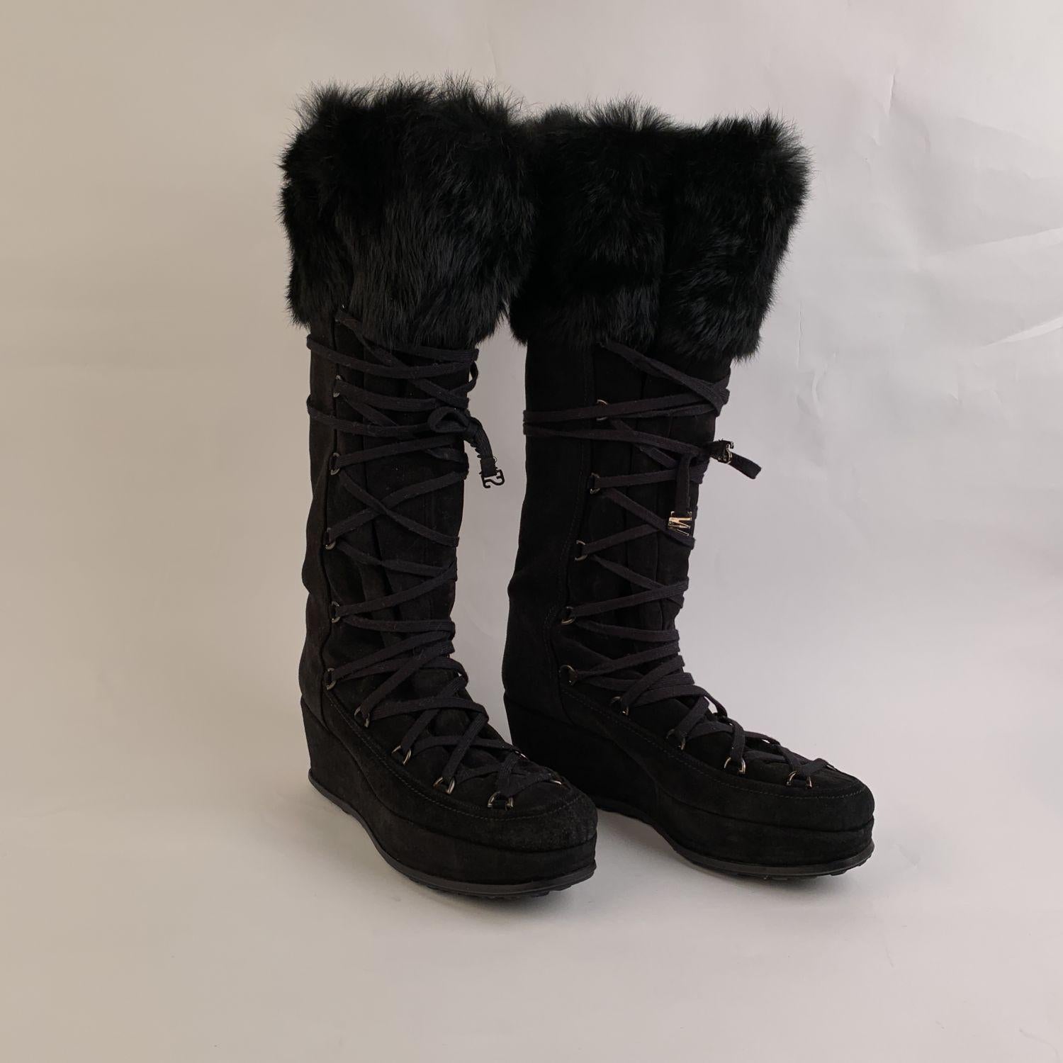 Stuart Weitzman black suede lace up wedge boots. They feature fur trim on the top. Rubber sole. Heels Height: 2.5 inches - 6.4 cm. Shaft height: 16 inches - 40.5 cm. Size: EU 39.5 (The size shown for this item is the size indicated by the designer